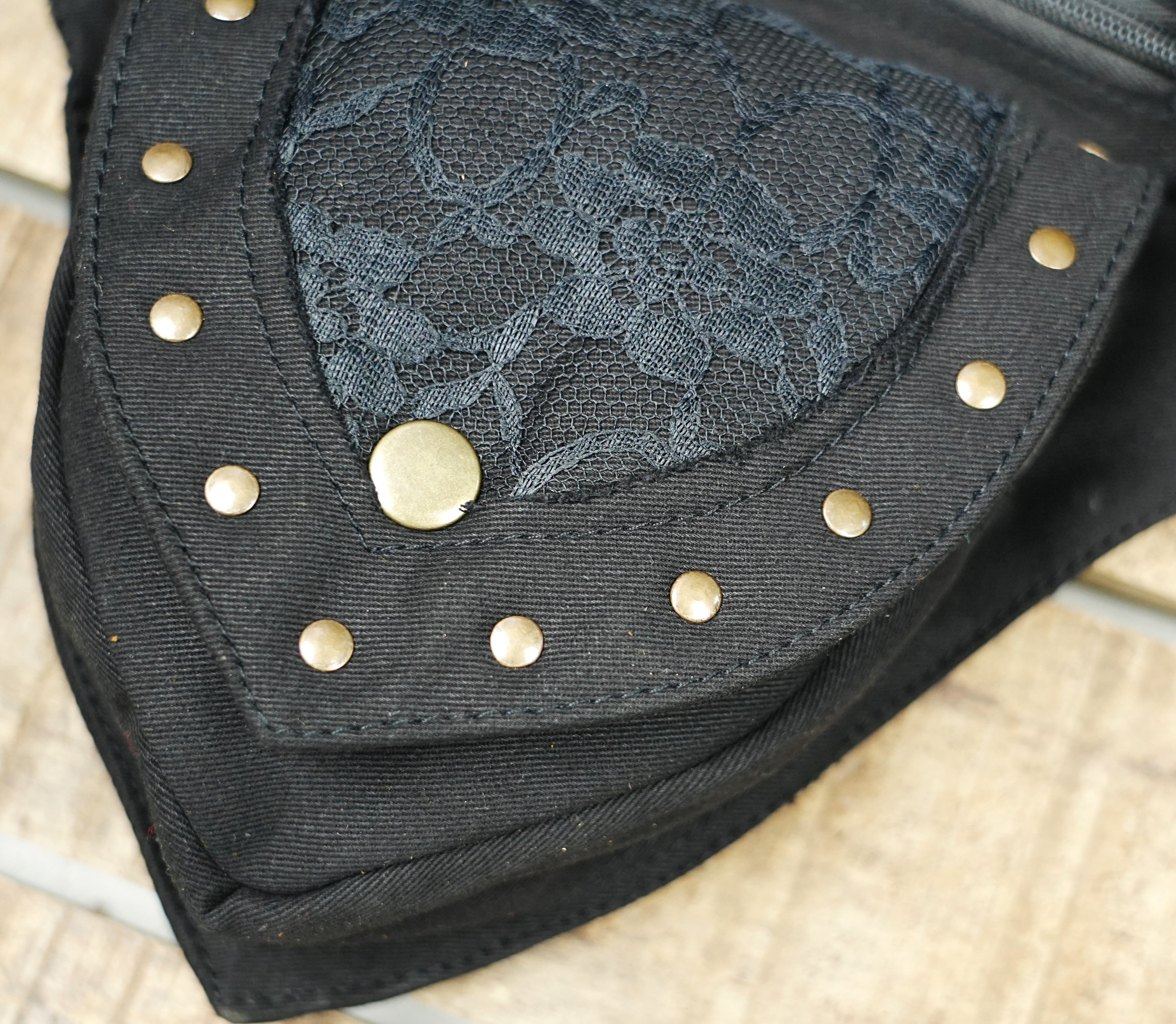 Alternative rave bum bag with pointed leaf flap and floral lace details
