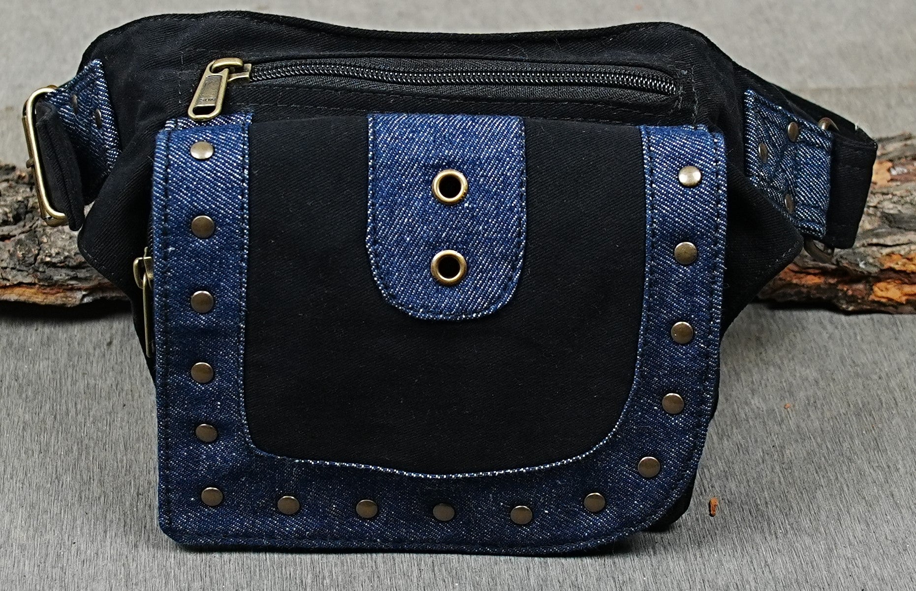 Studded denim festival hip bag with brass eyelets and adjustable strap