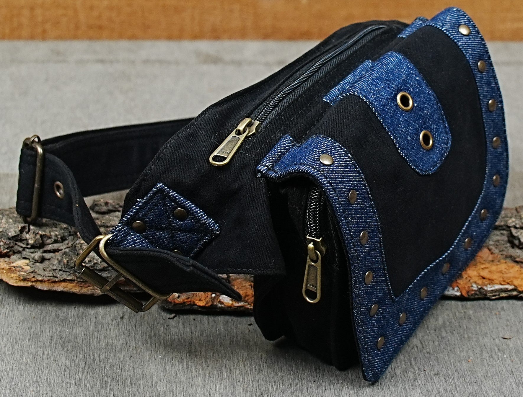 Festival bum bag with zip pocket and brass buckle on rustic wood