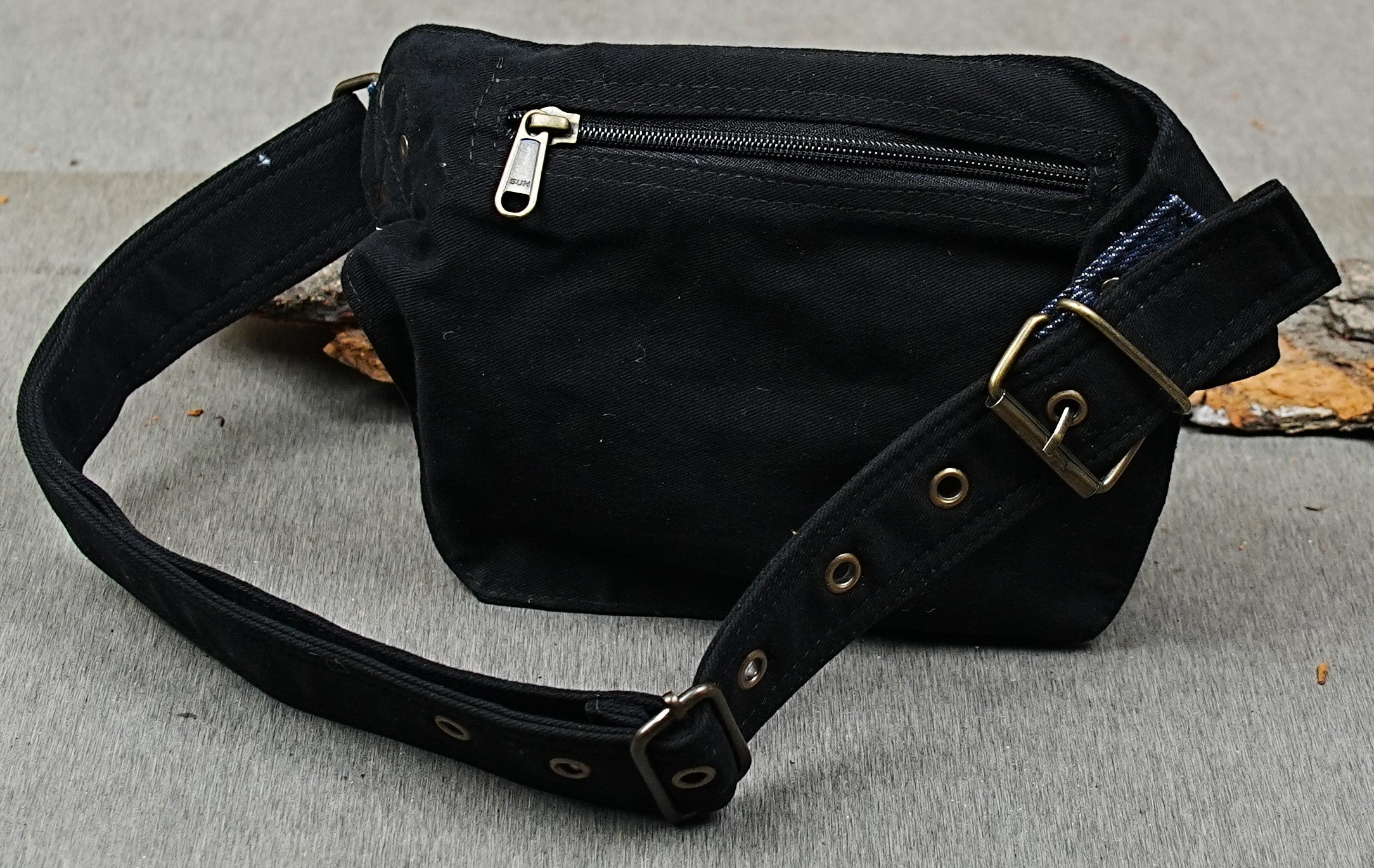 Denim trim festival hip pouch with studded flap and adjustable grommet belt