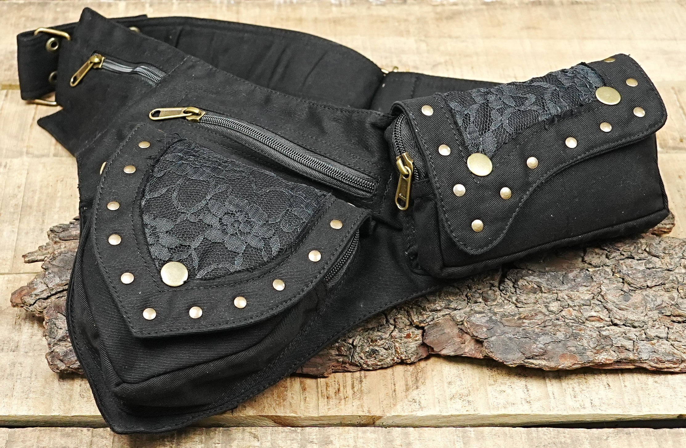 Bohemian tribal utility waist bag with studded curved flaps laid open