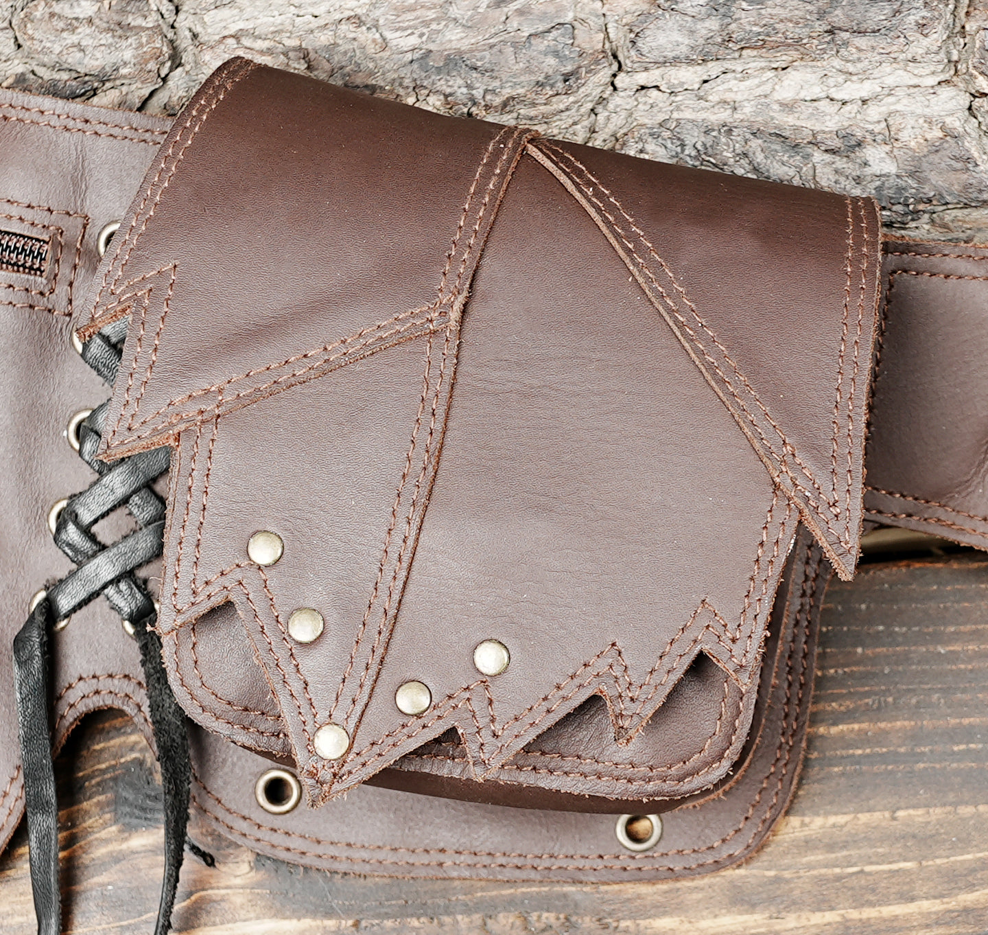 Western style leather hip bag with decorative stitching and rivets
