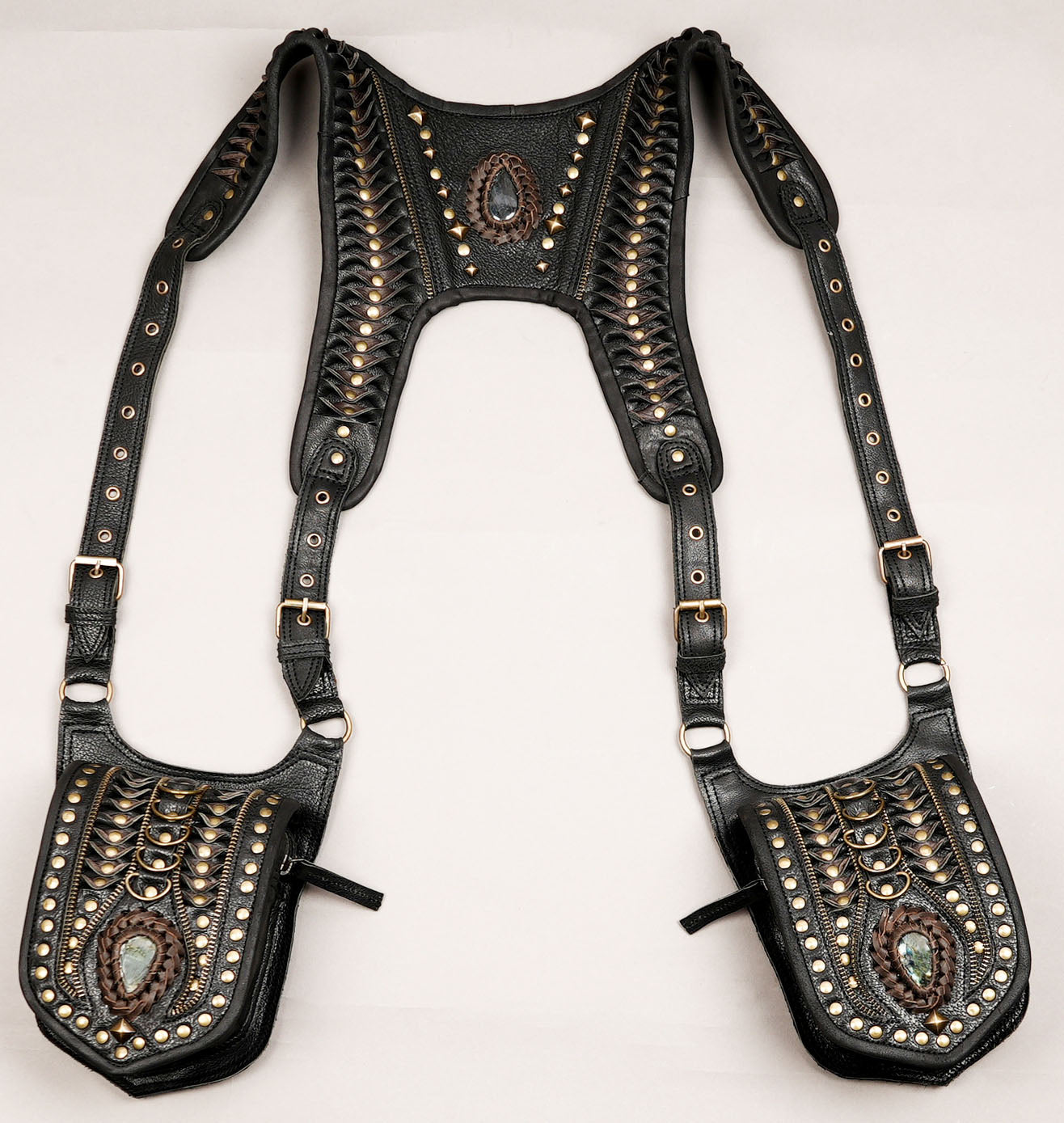 Leather harness utility bag displayed on wooden plank surface