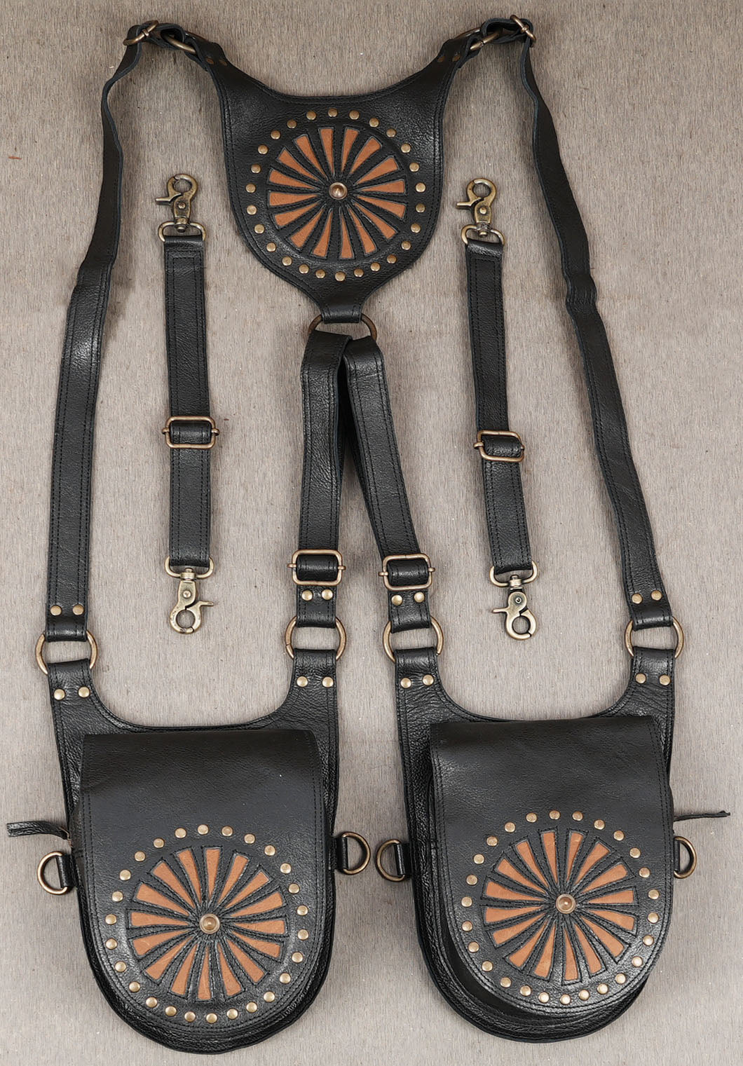 Black leather dual holster harness with sunburst stud design