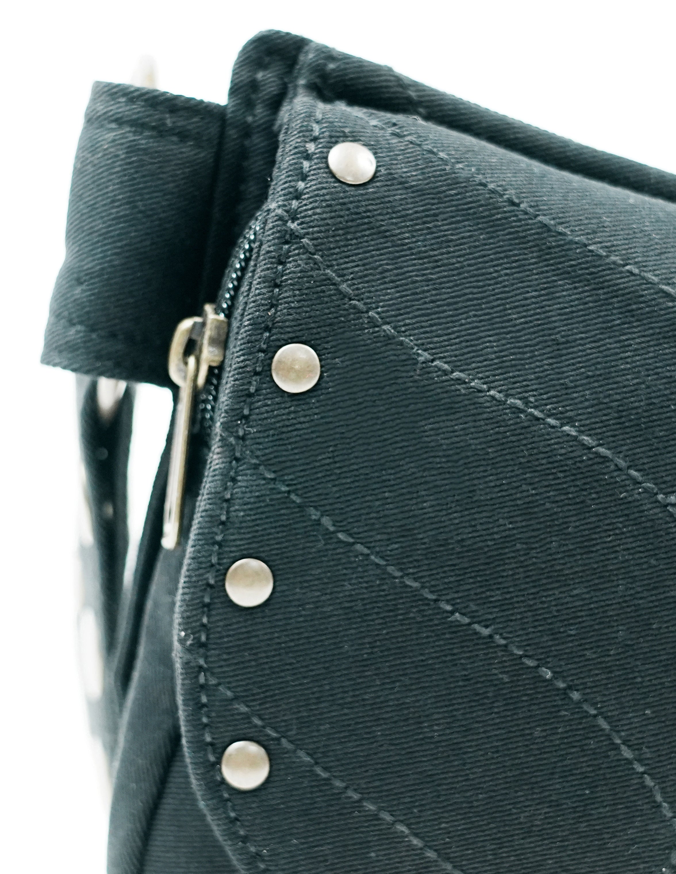 Black canvas fanny pack with dual pockets and metal studs