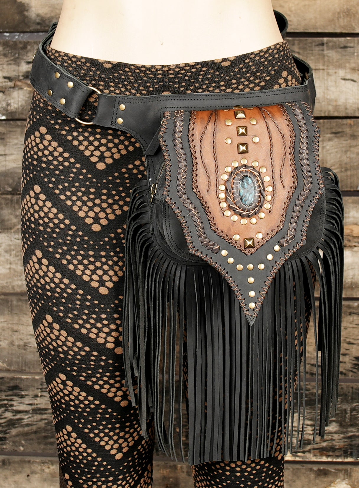 Unique handmade leather belt bag with gemstone and boho fringe.