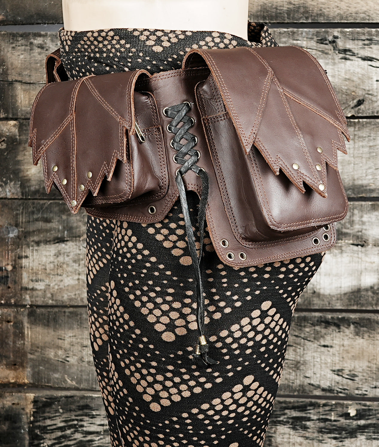 Multi-compartment brown leather waist pack for outdoor events
