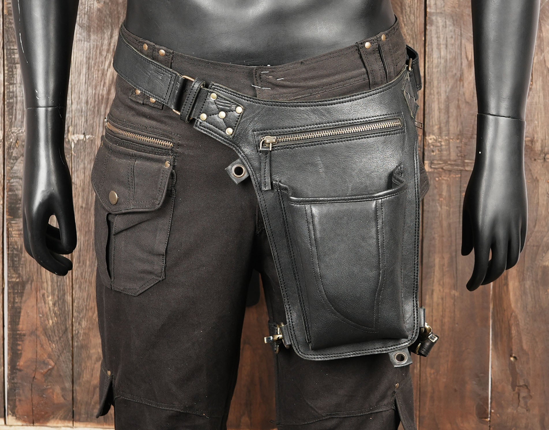 A handmade black leather waist and thigh belt with pouch, designed for festivals, cosplay, steampunk, and daily adventures.