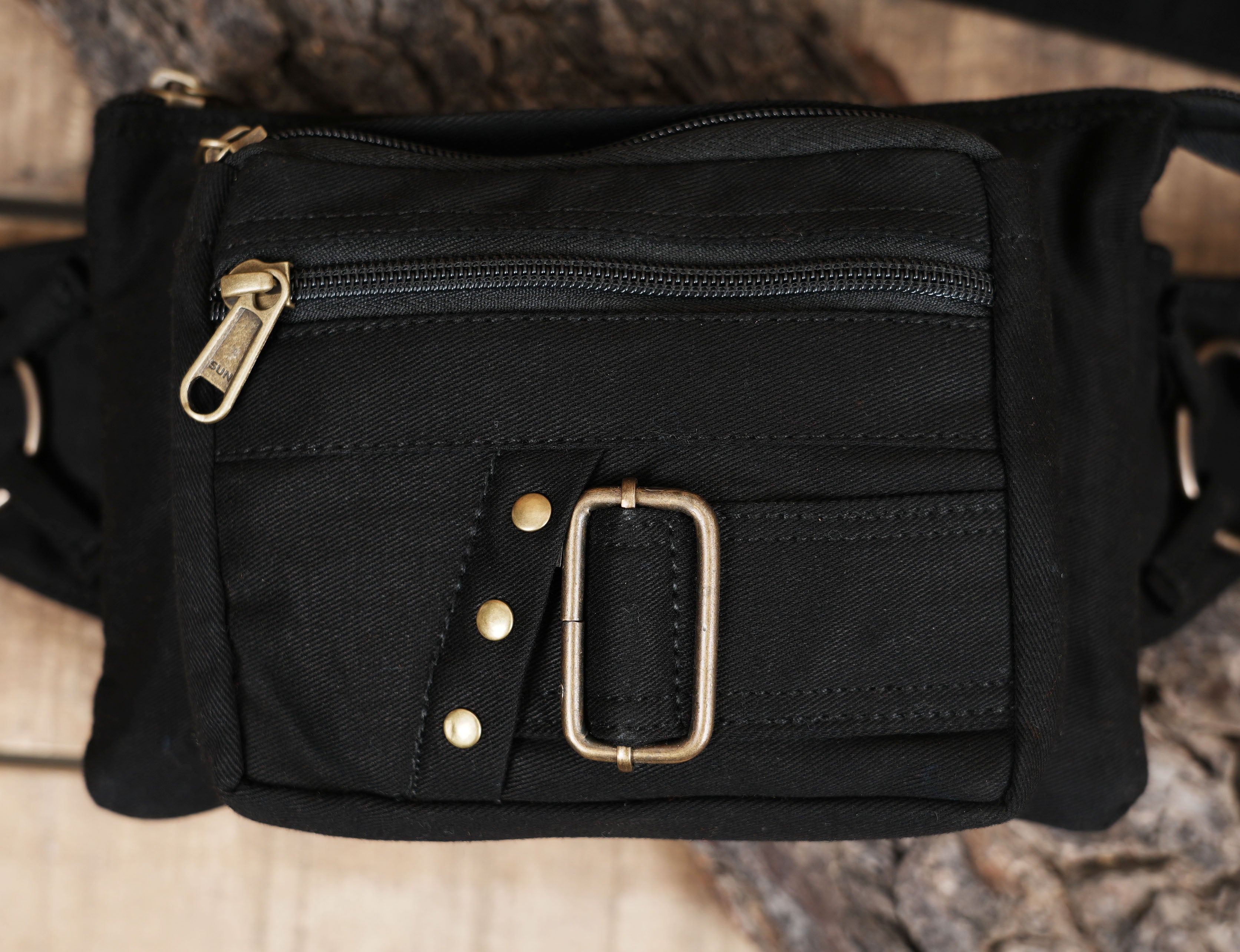 Hands-free black hip pack with antique brass hardware and grommets