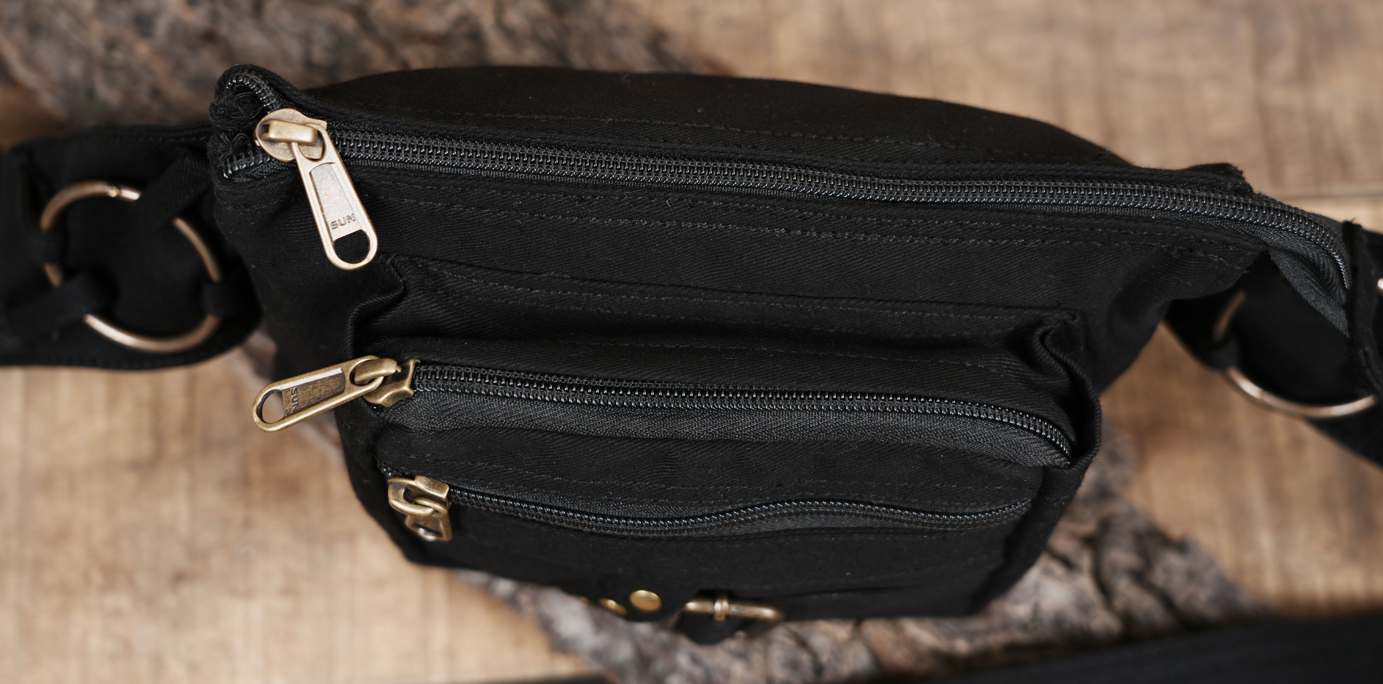 Utility waist bag in durable black cotton with brass accents
