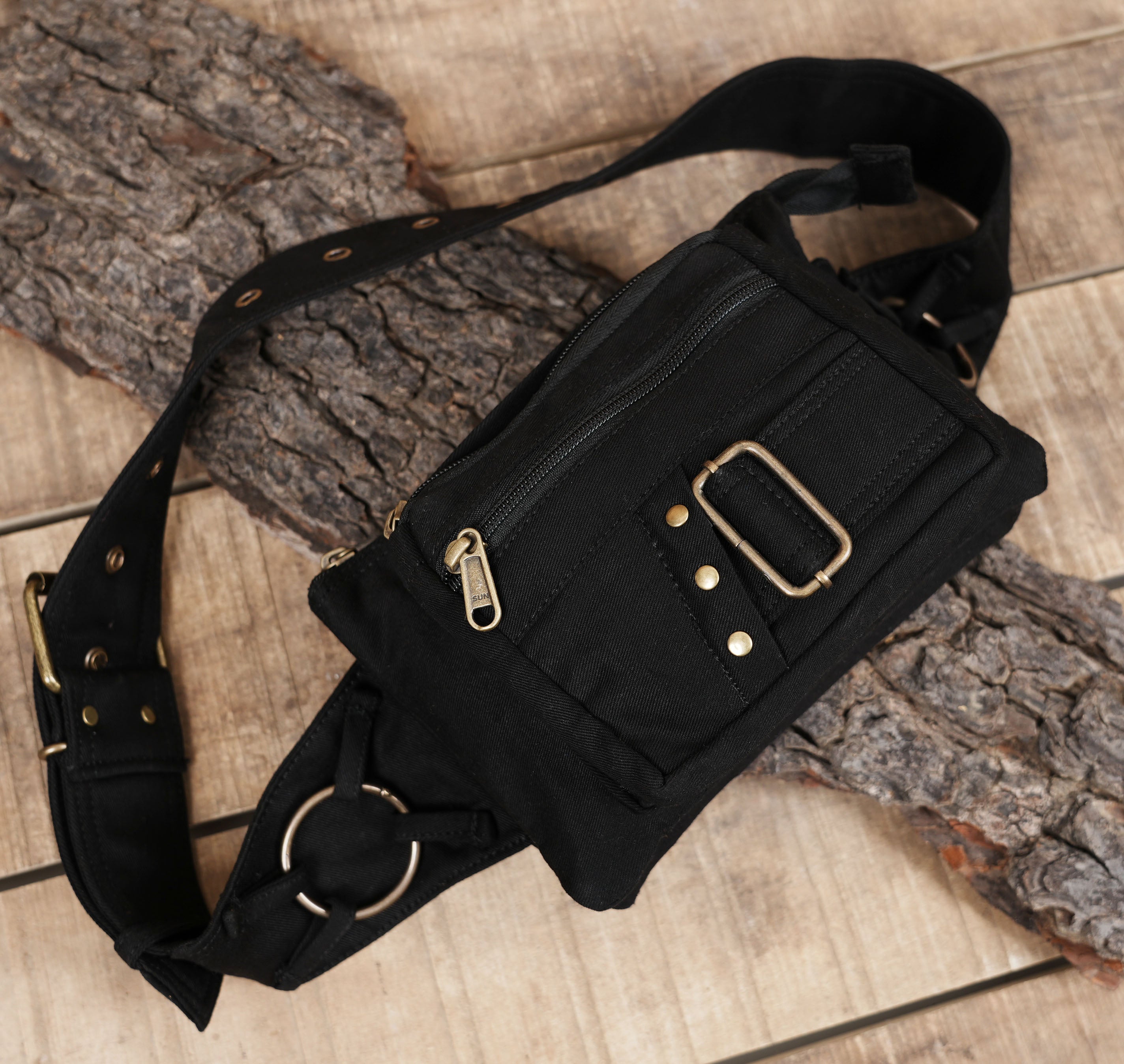 Practical black cotton waist pack with grommet details for travel