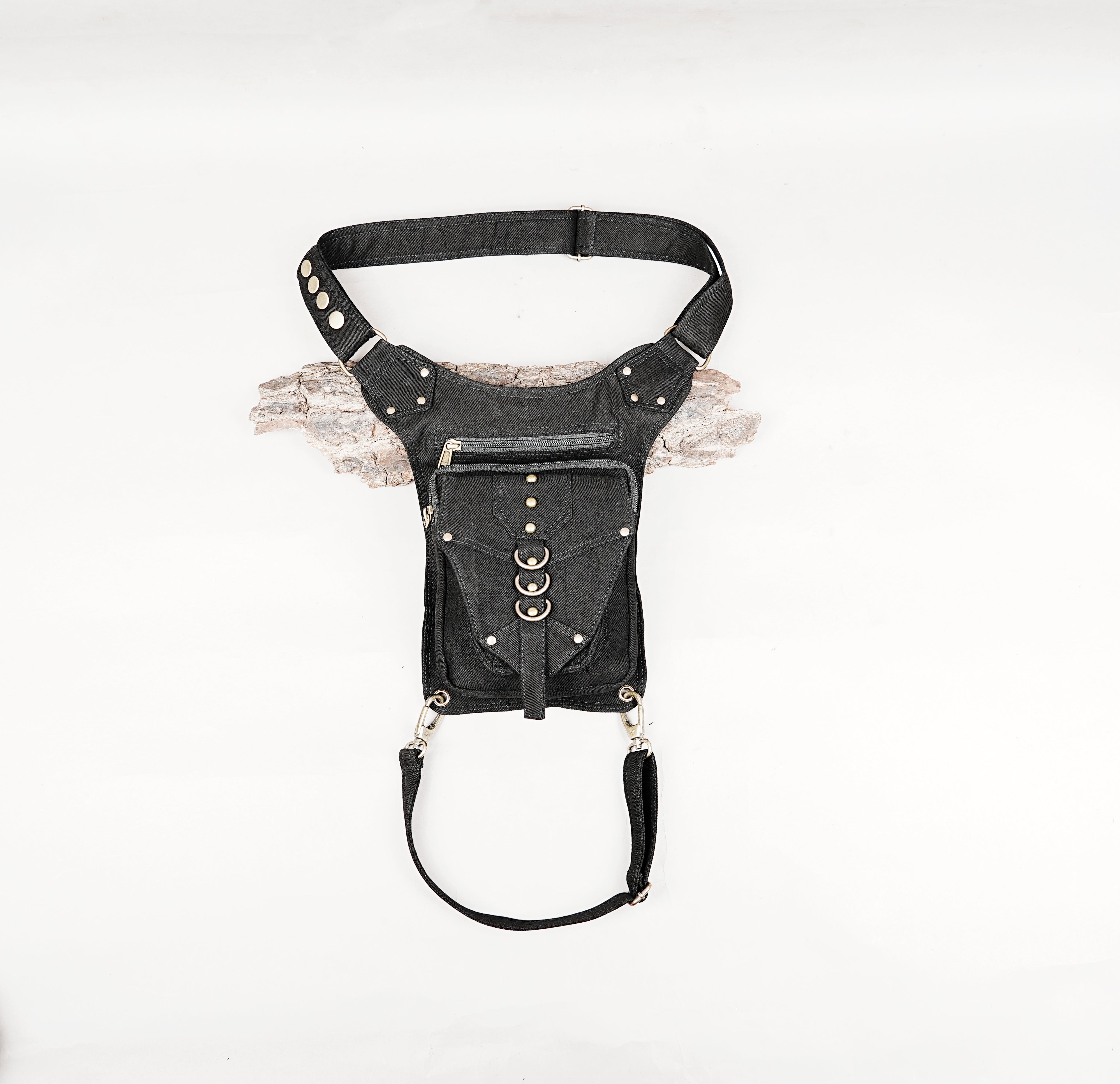 Handmade black cotton canvas drop leg thigh bag with metal ring details laid flat on a clean white background.