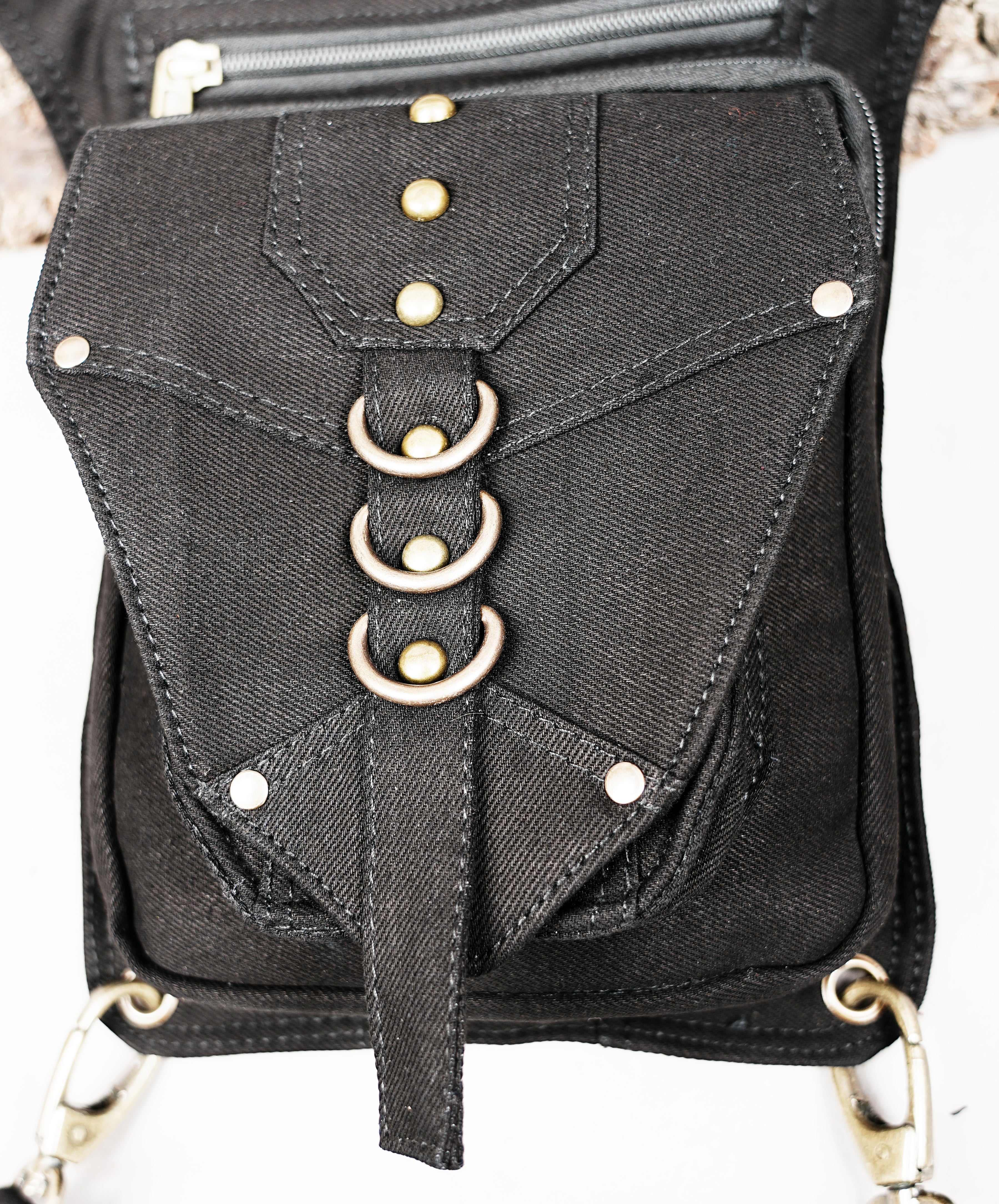 Black festival thigh pocket belt with adjustable leg strap and studded metal accents.