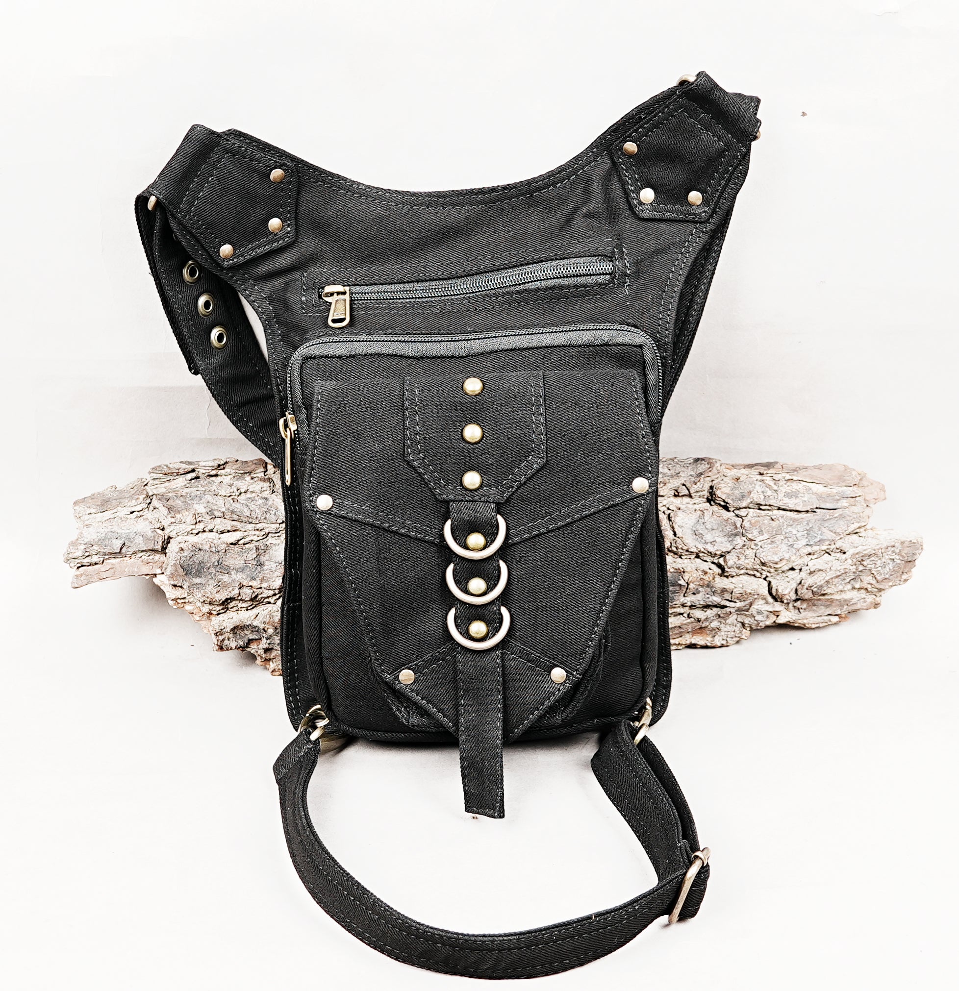 Tribal style black canvas side thigh pack with front flap pocket and brass ring trims.