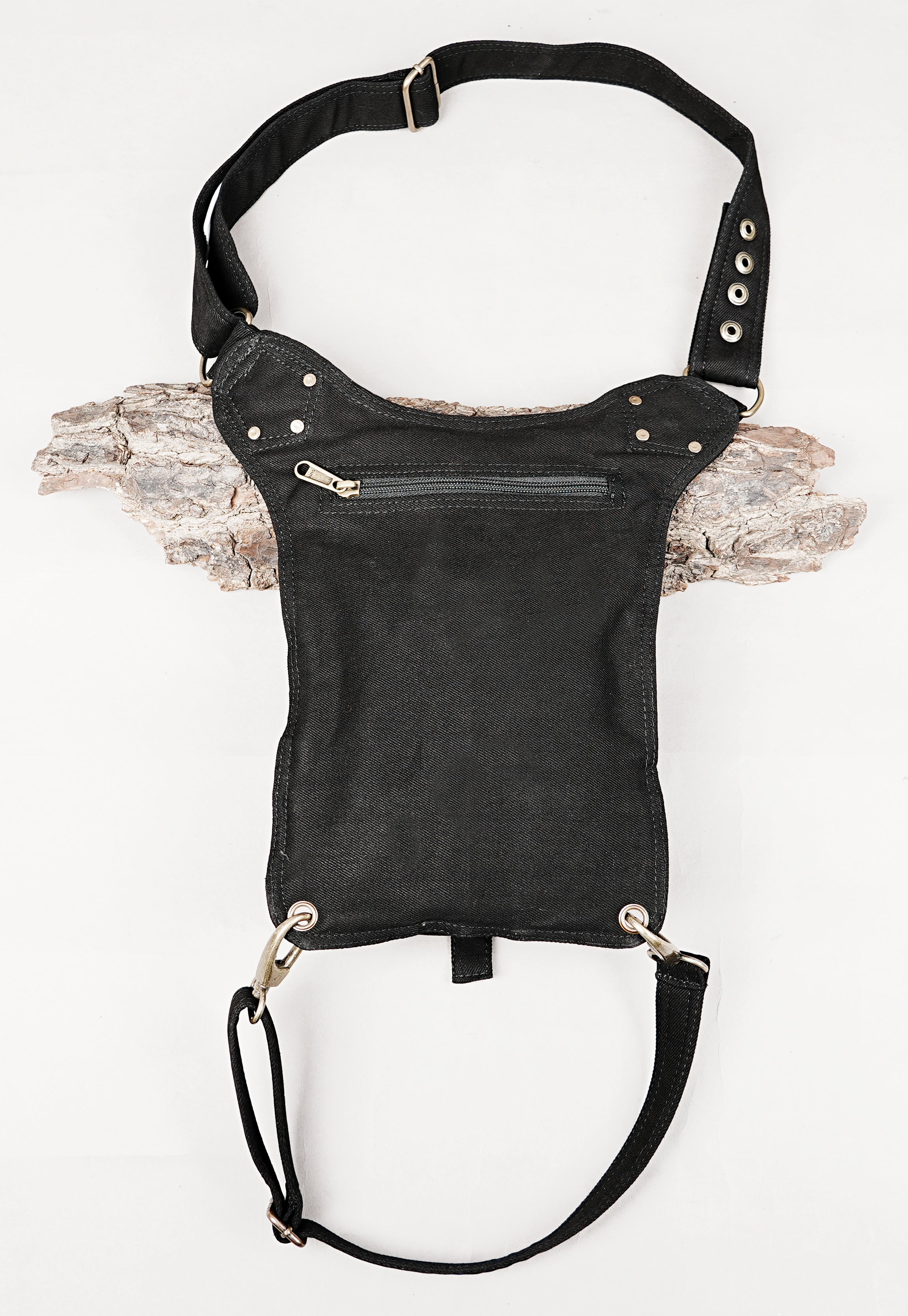 Alternative streetwear side pouch bag in black canvas with brass ring detailing.