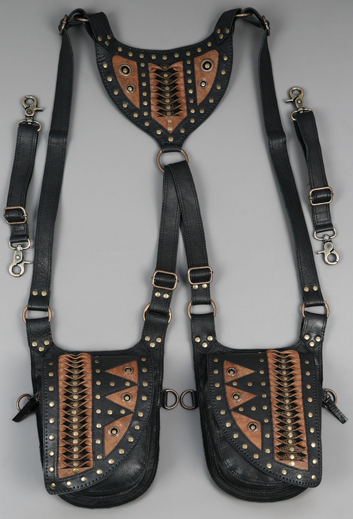 Handmade black leather dual holster with brass studs and tribal detailing