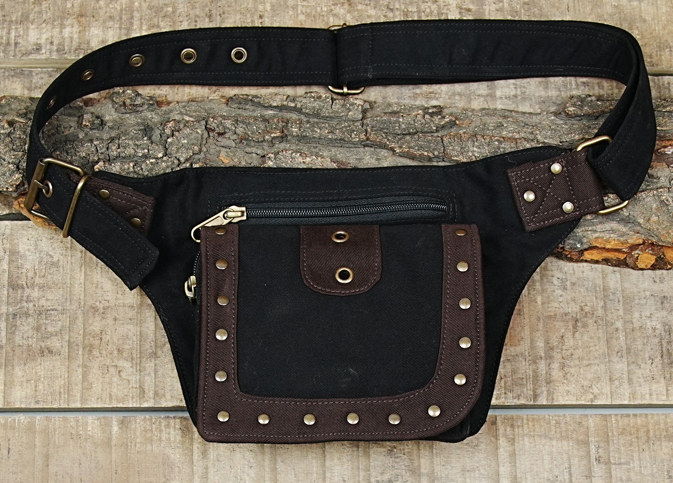 Biker style black waist pouch with heavy brass buckle and denim contrast