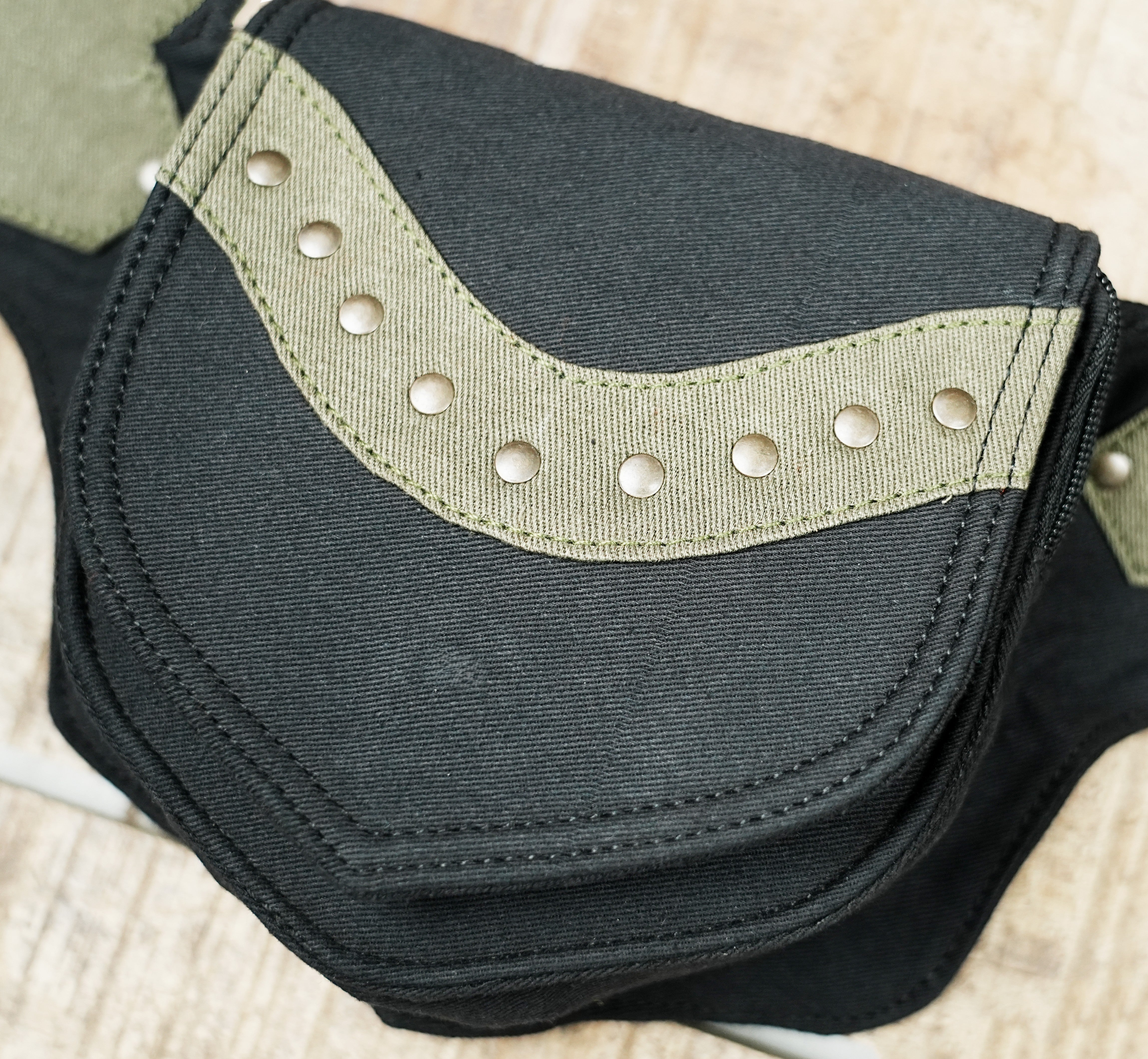 Pixie utility waist pouch with curved green accent band and metal rivets
