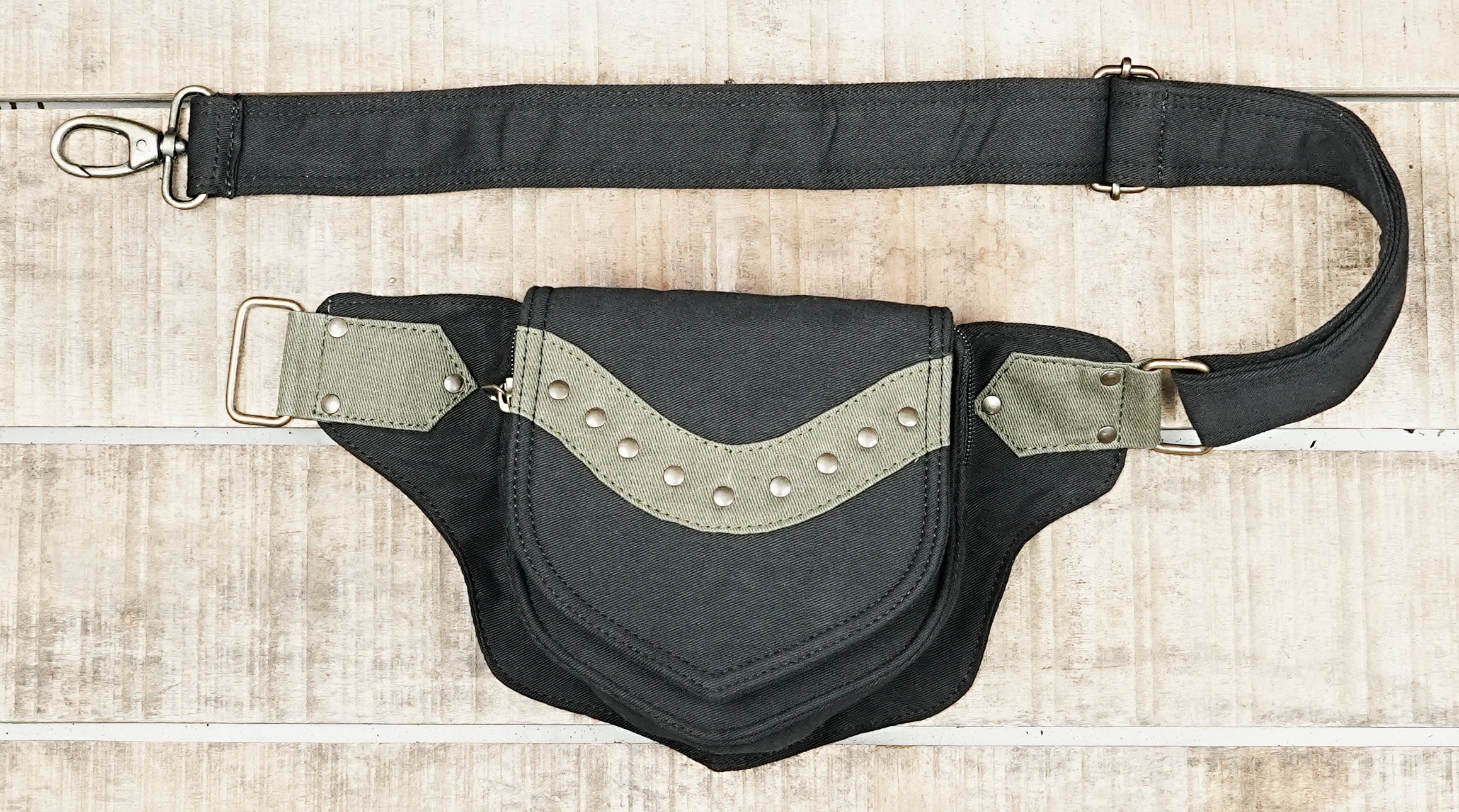 Flat lay of black cotton canvas bum bag with adjustable strap and metal ring