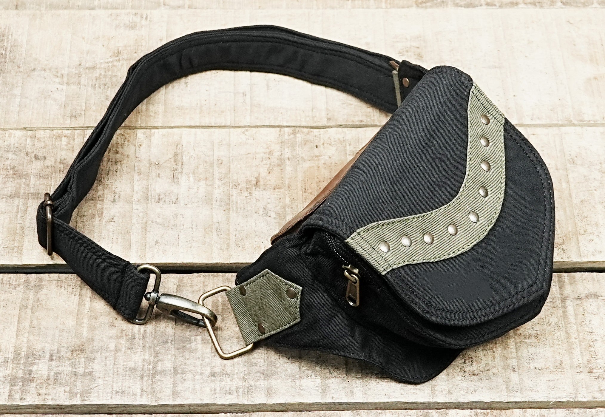 Compact canvas hip bag with studded flap for concerts and outdoor events
