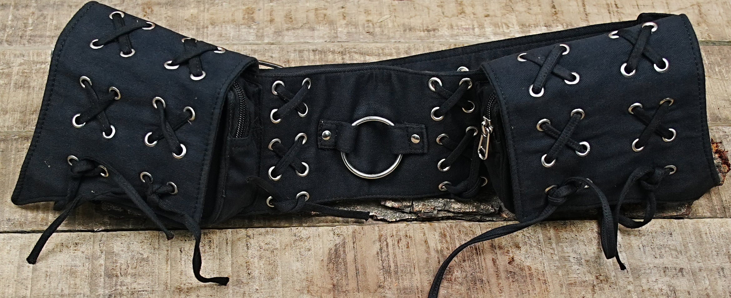 Gothic-inspired black canvas hip belt fanny pack with secure metal studding and lace-up details.