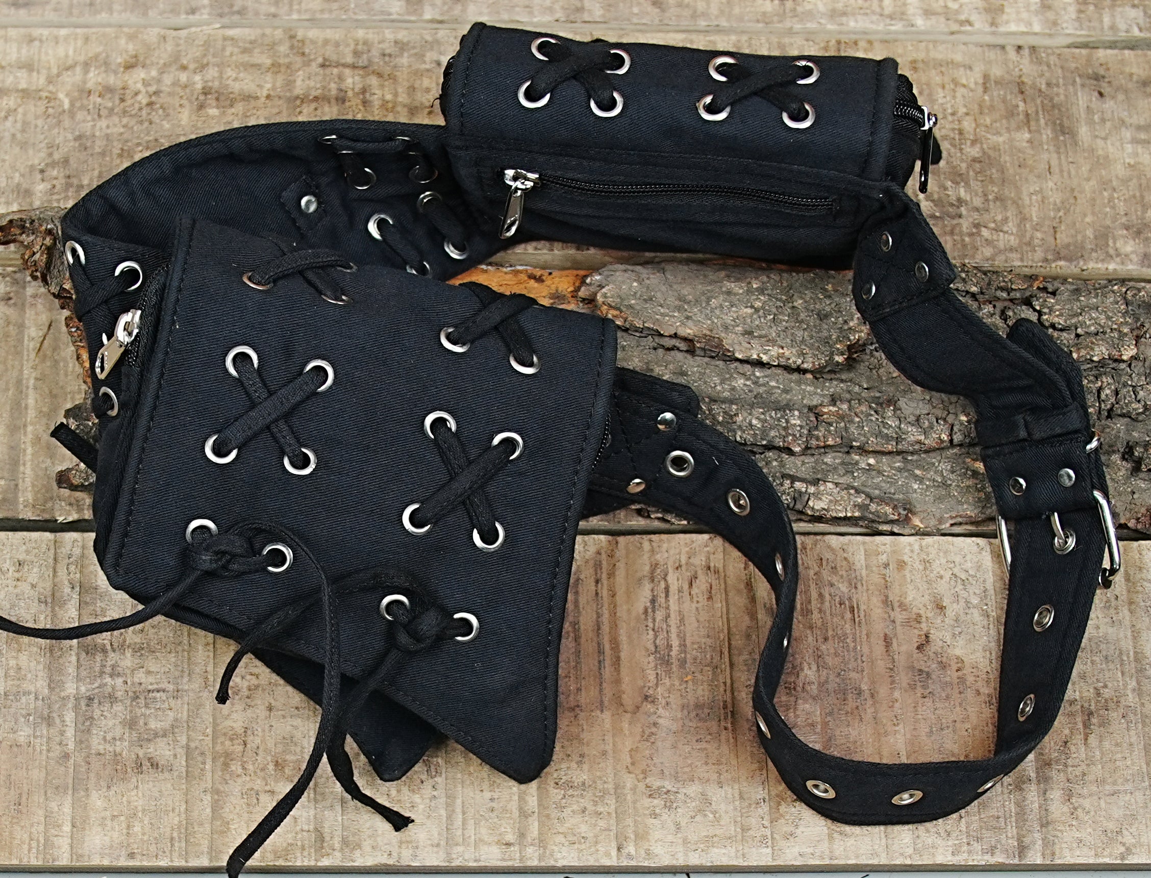An alternative style utility fanny pack with secure metal riveted details and durable stitching.