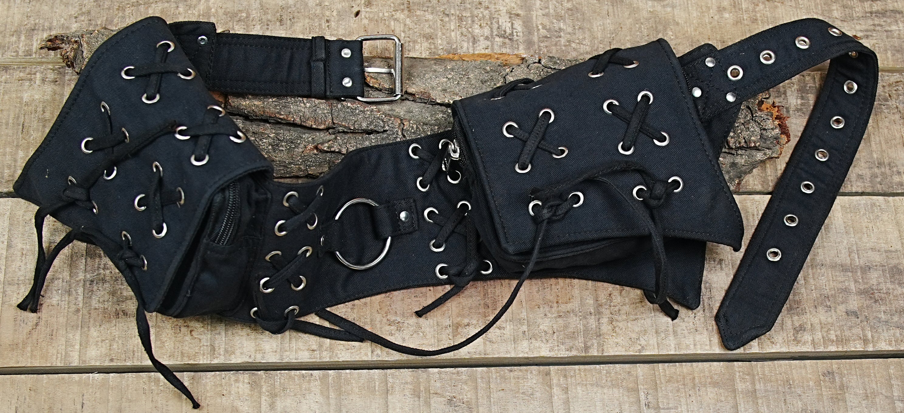 Premium alternative fashion waist pack with a raw, industrial-style utility aesthetic.