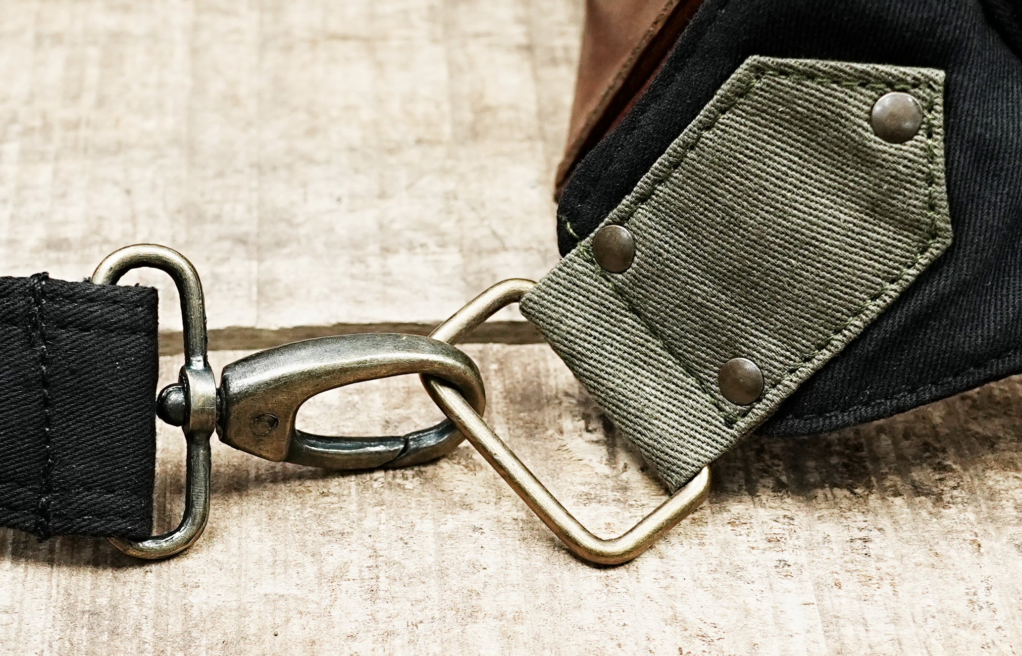 Hands-free travel money pouch in black canvas with olive green detailing