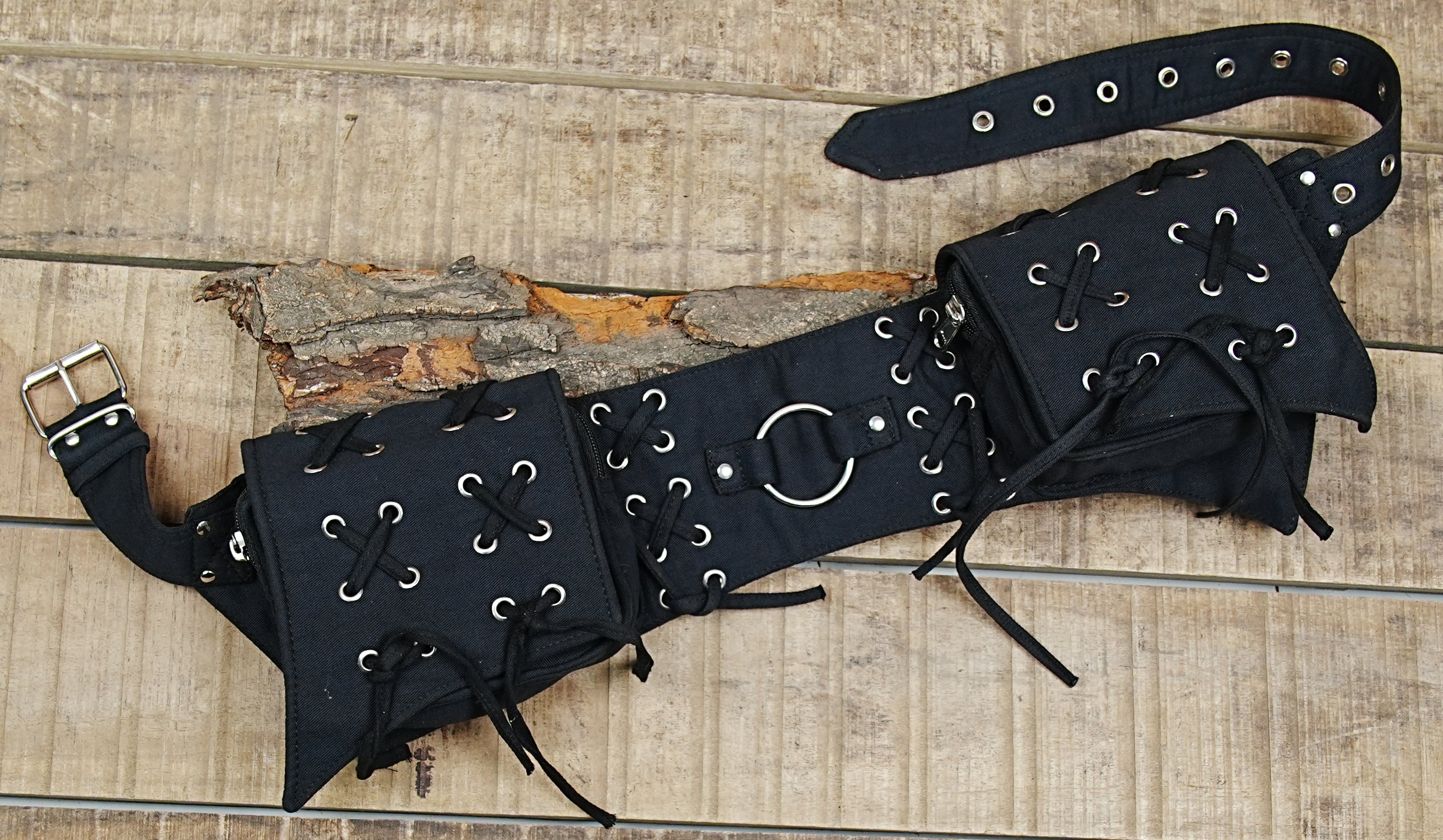 Unisex black cotton waist bag with an edgy, utilitarian design, shown flat.