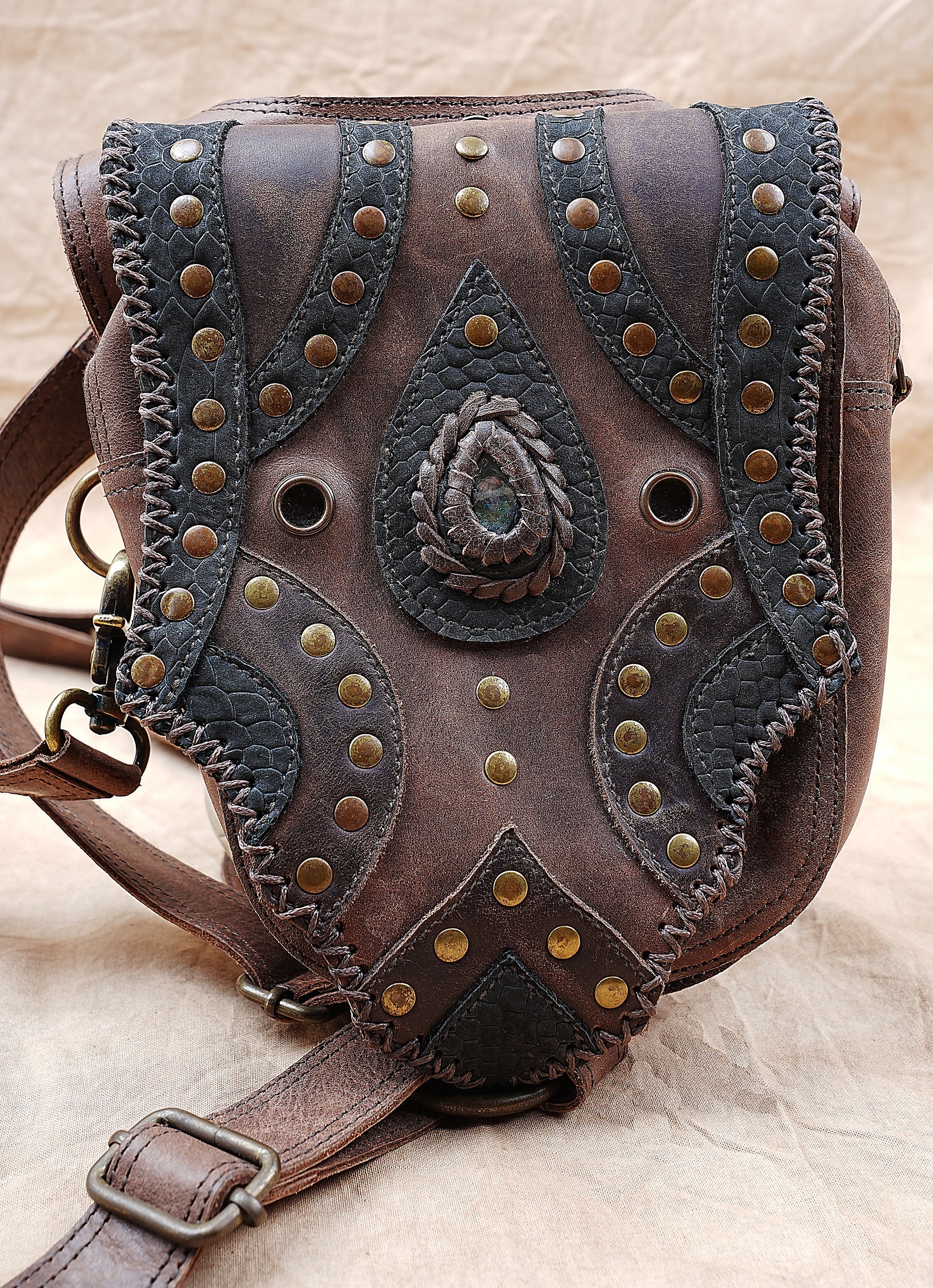 Artisan leather holster with brass studs and natural stone inlay
