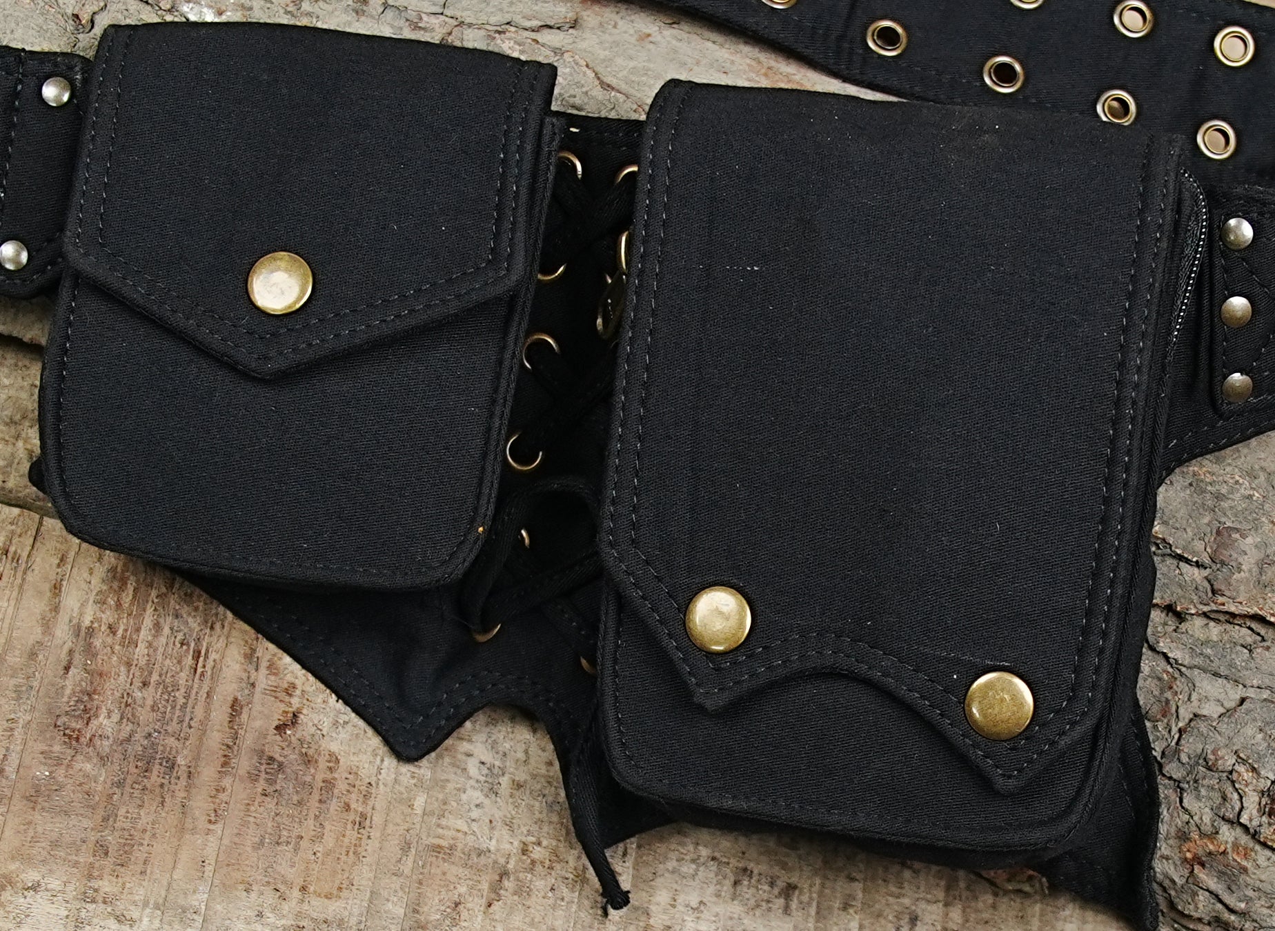 Black lace-up festival hip bag with pointed pixie hem and brass buckle