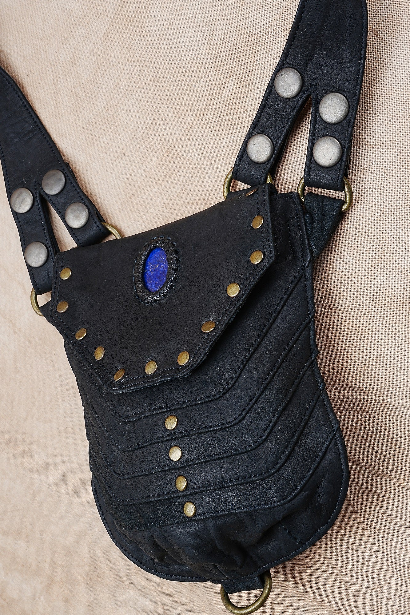 Handmade leather holster harness with rivets and stone inlay design