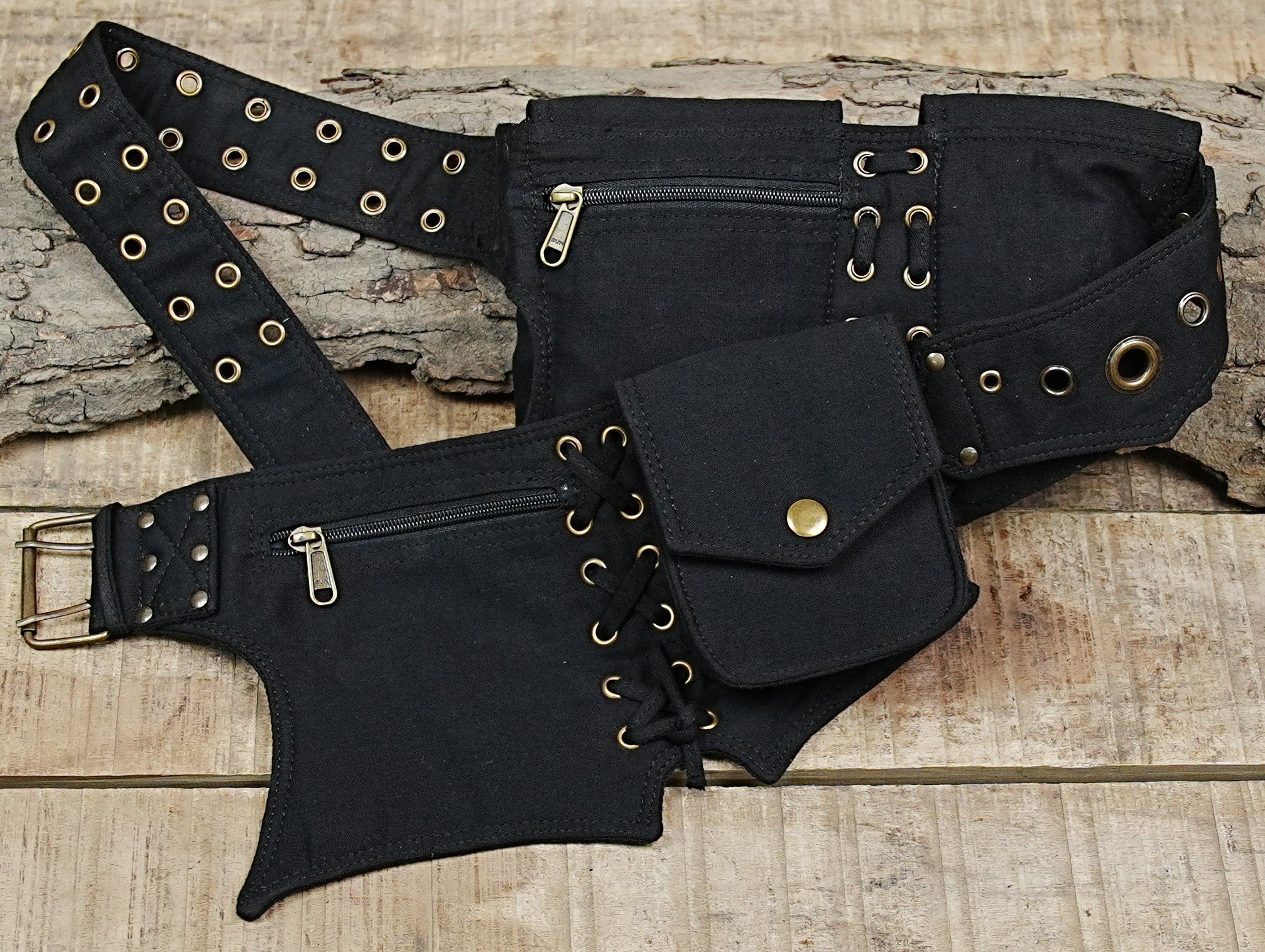 Black canvas festival fanny pack with pointed panels and metal eyelet details