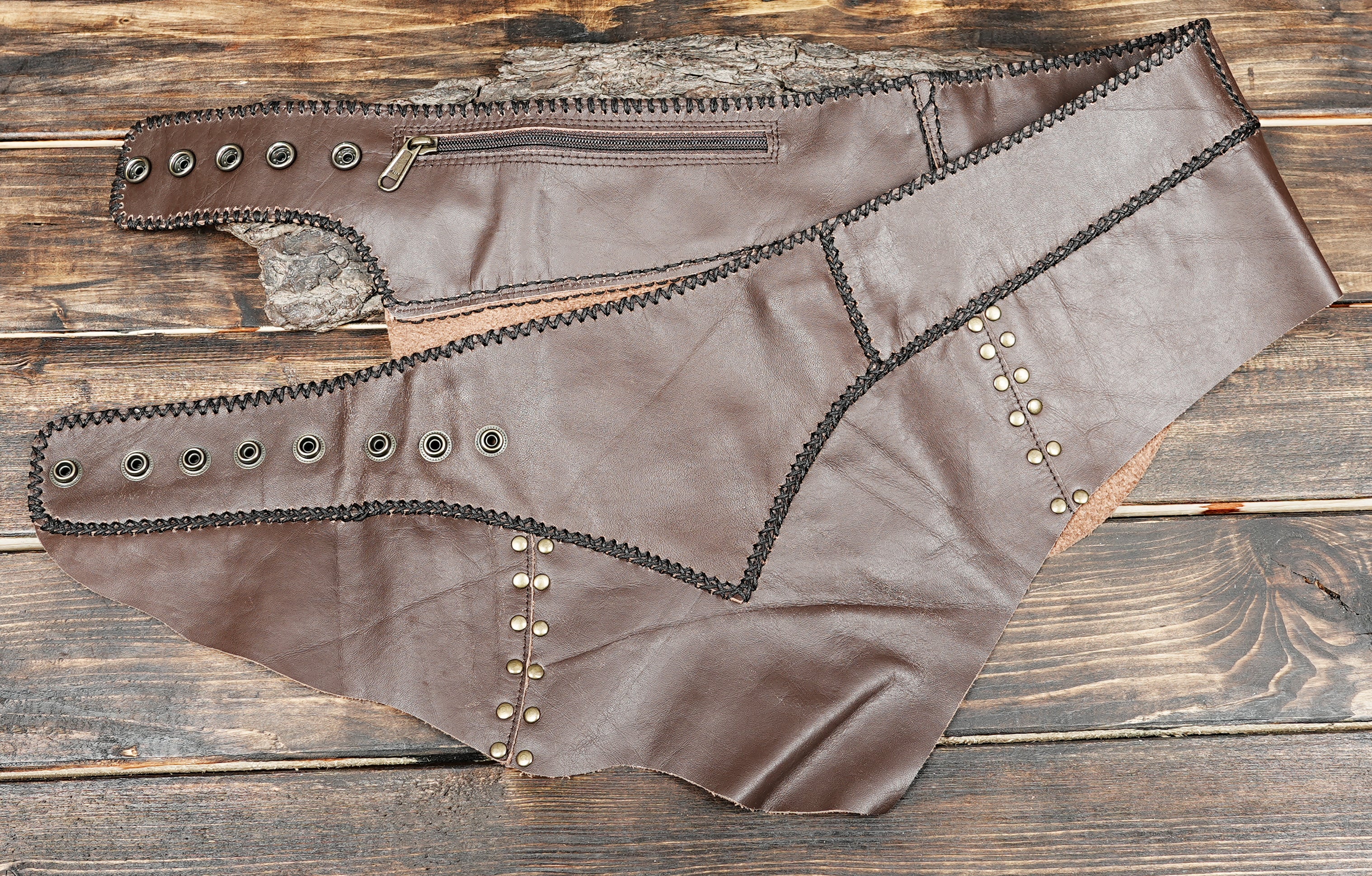 Brown leather studded skirt with asymmetrical cut and boho tribal design for cosplay and festivals.”