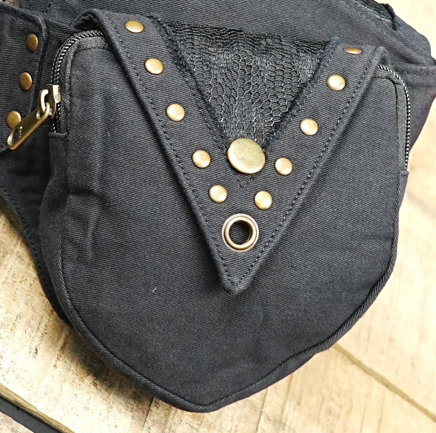 Alternative gothic waist pack with textured flap panels and brass studs