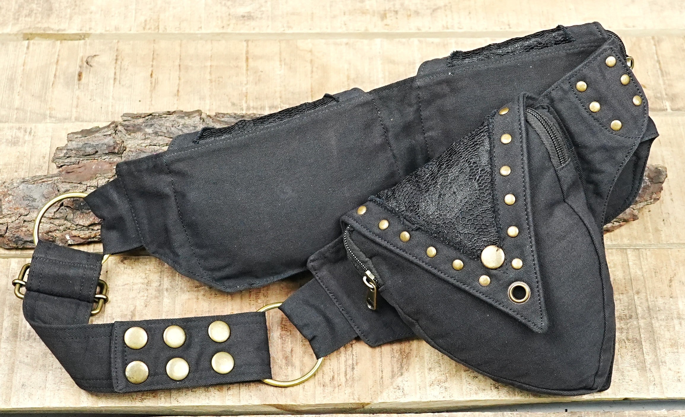 Tribal style waist pack with metal rivets and brass eyelets on rustic background