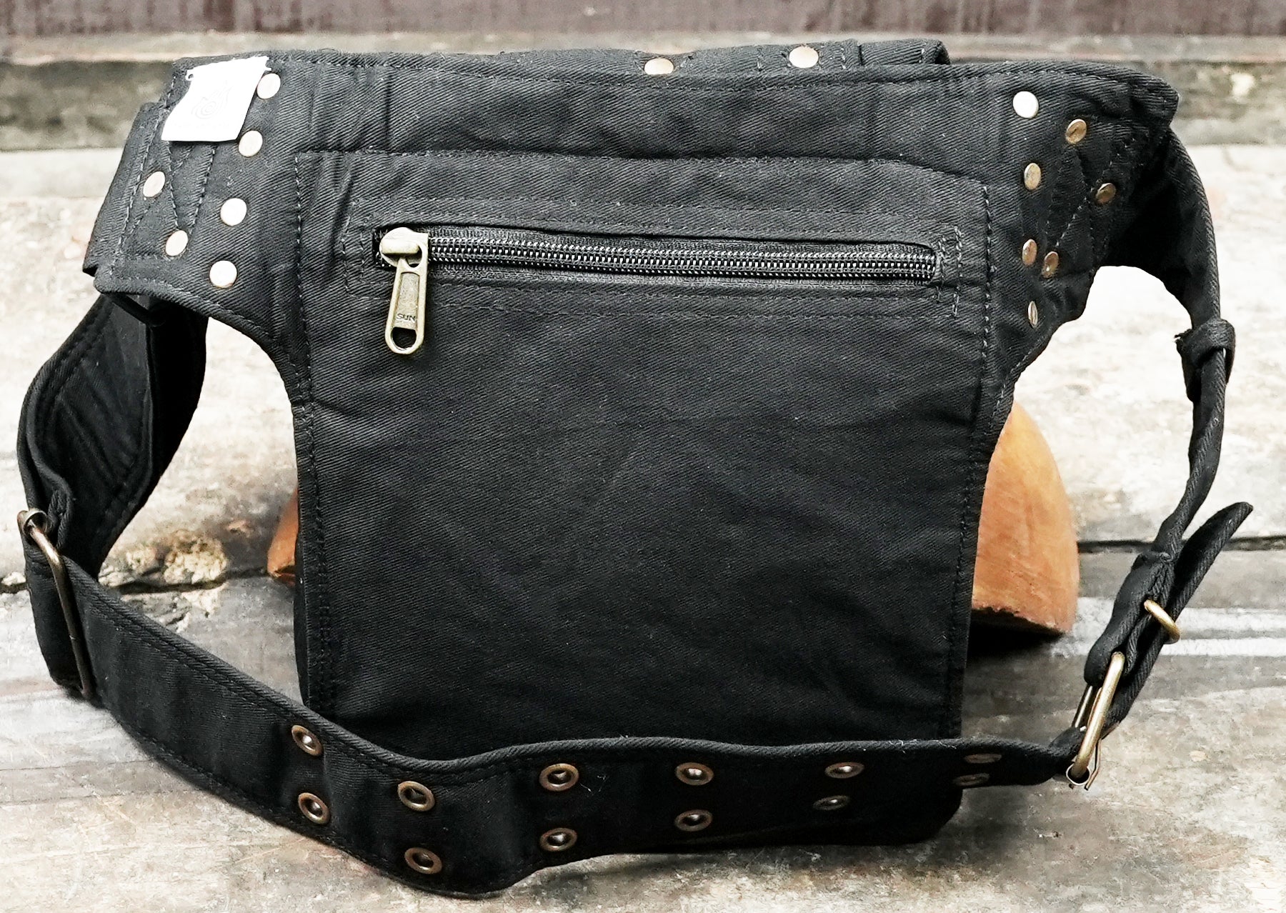 Compact travel hip bag in durable black canvas for concerts and festivals