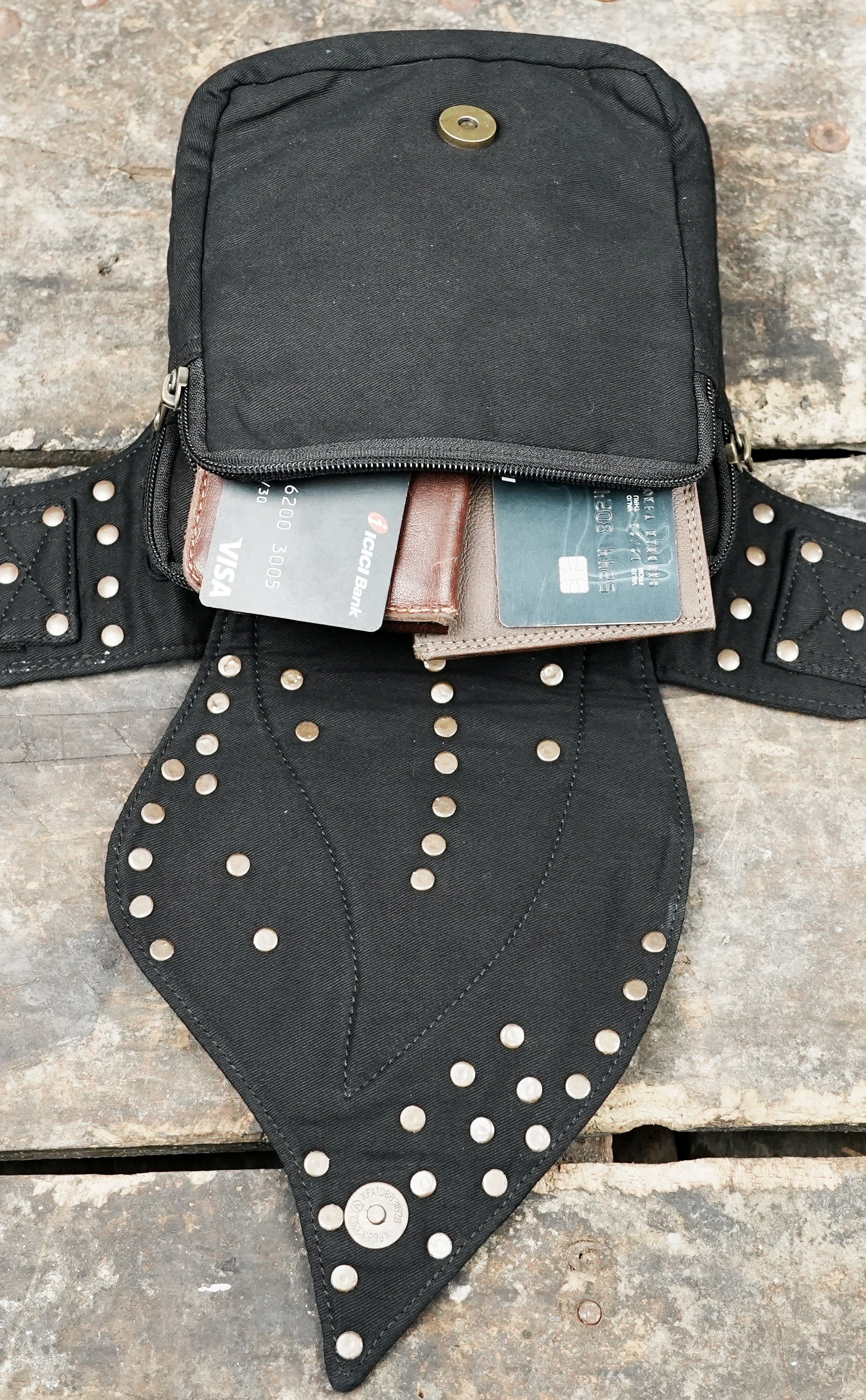 Alternative streetwear waist pack with studded curved flap and side rings