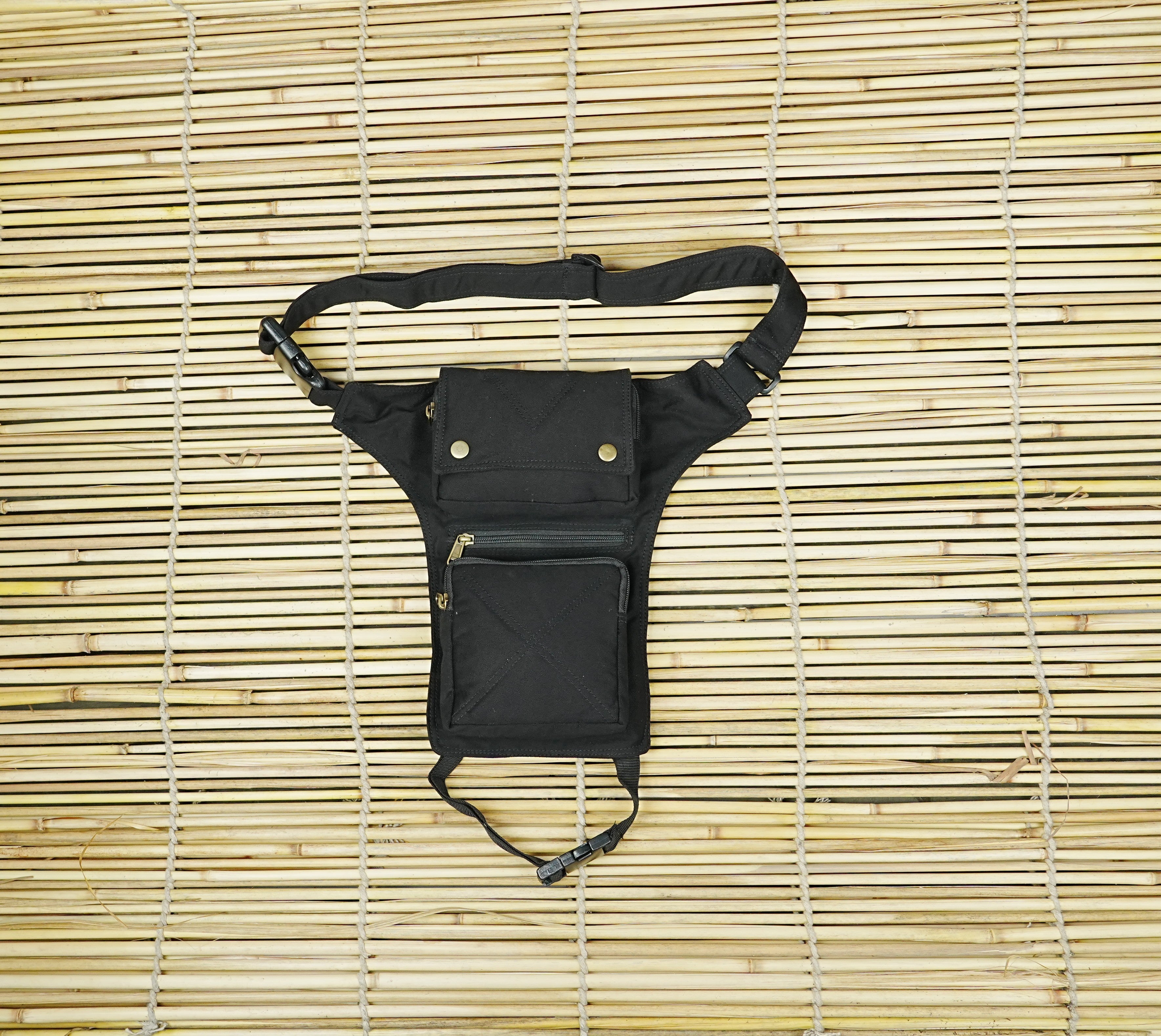 Black canvas drop leg bag with adjustable waist and leg strap