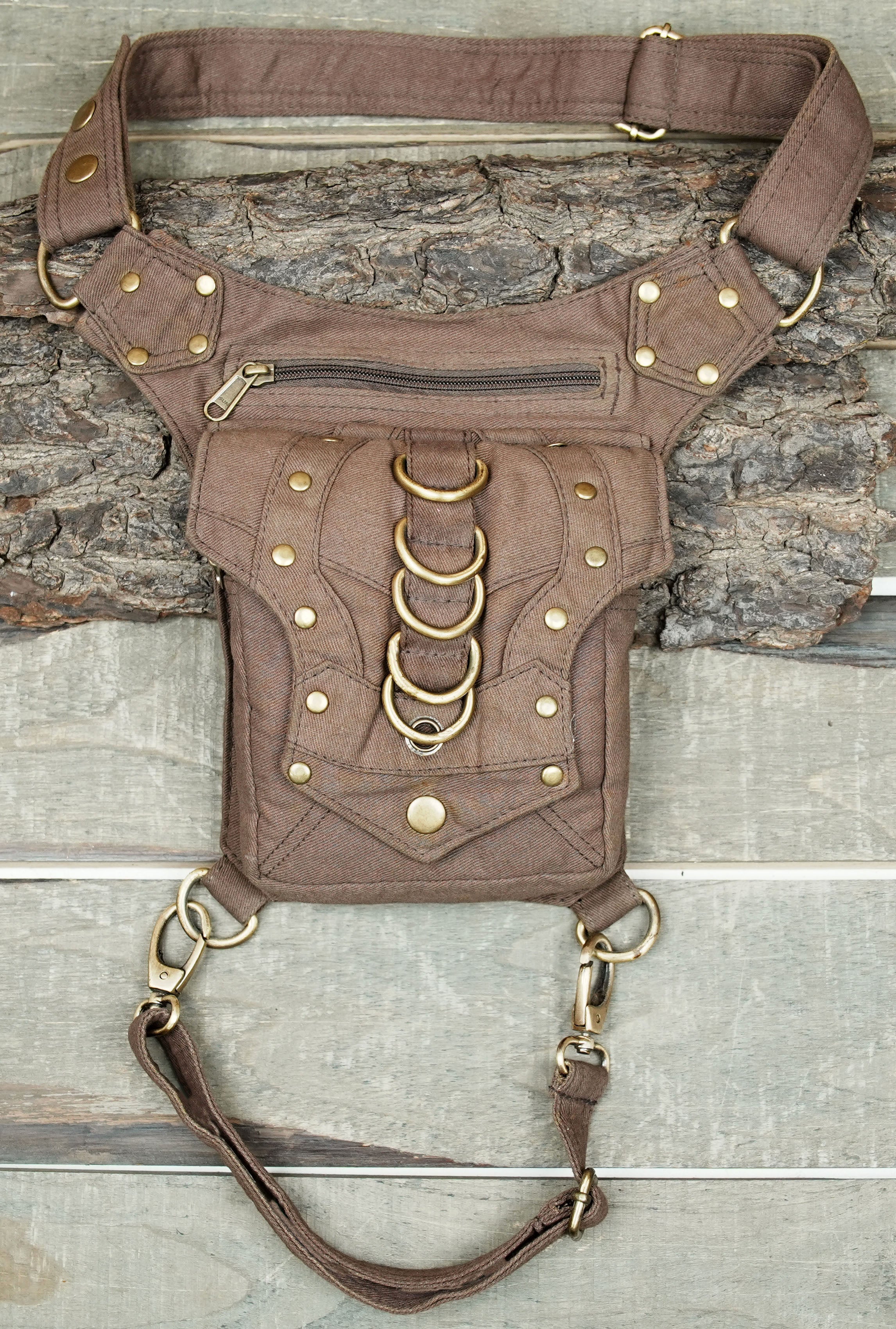 Alternative streetwear side pouch bag in canvas with brass ring detailing.