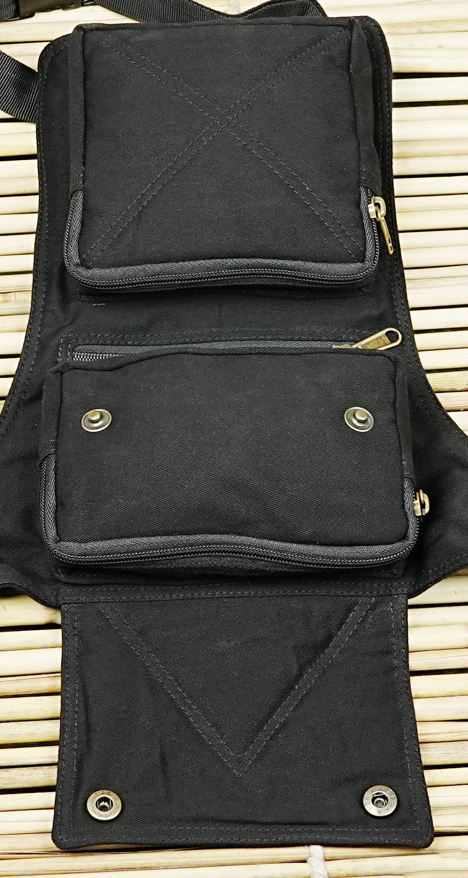 Black utility thigh bag with brass snap buttons