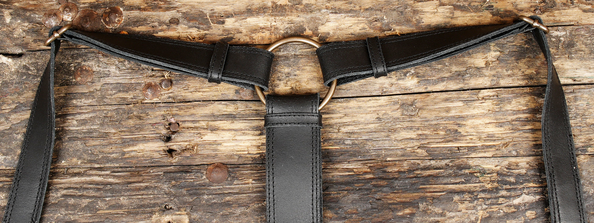 "Handcrafted black leather utility holster with brass hardware"