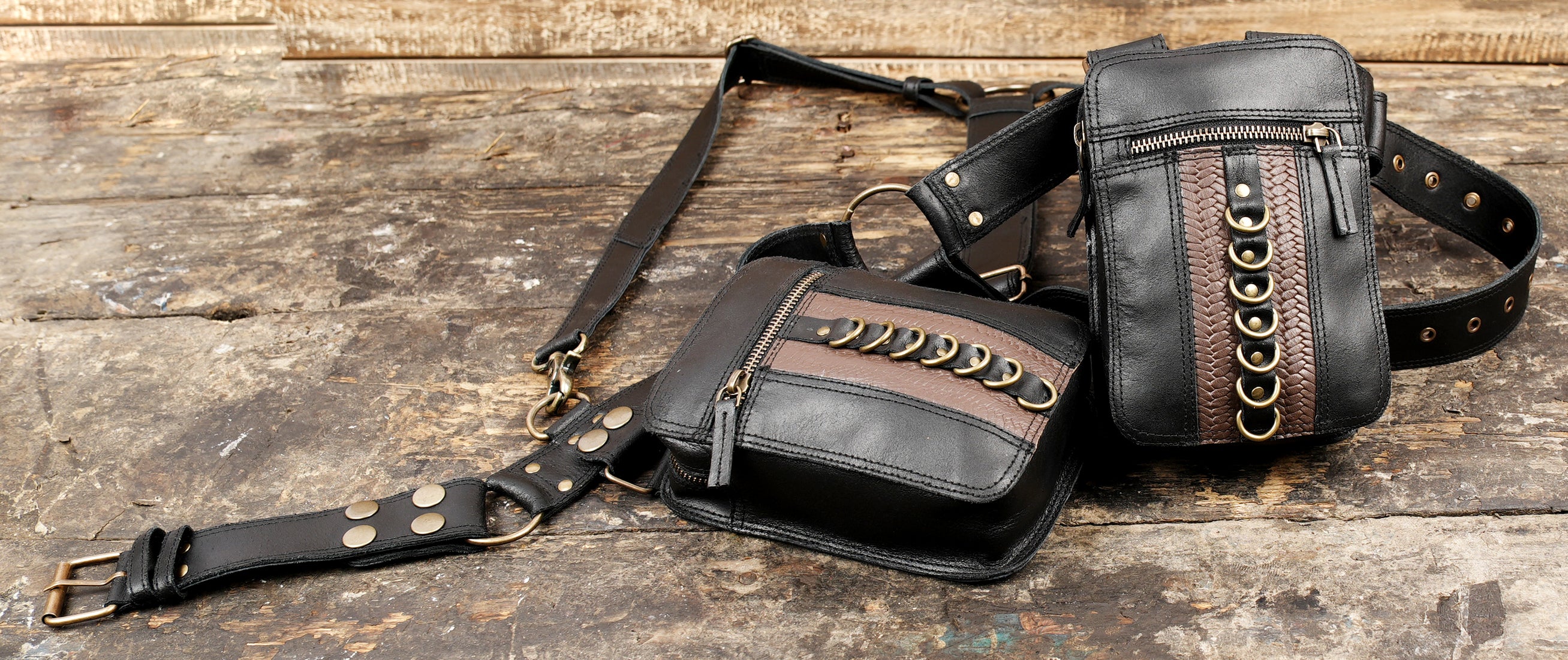 black leather harness bag with metal accents"