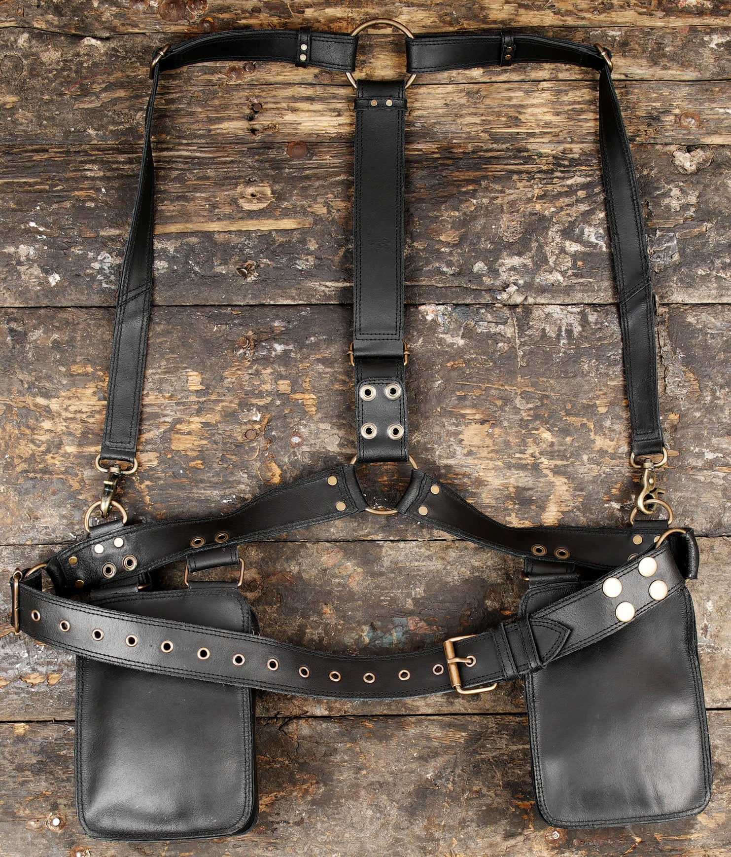   "Durable leather harness bag with adjustable buckle straps"  