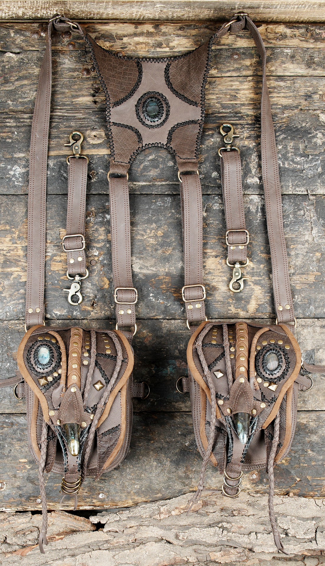 “Rustic black leather holster harness with gemstone decor and textured panels”