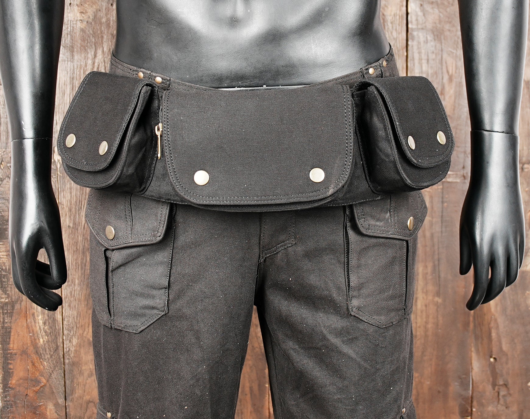 Black canvas waist pack with secure snaps and zipper pocket