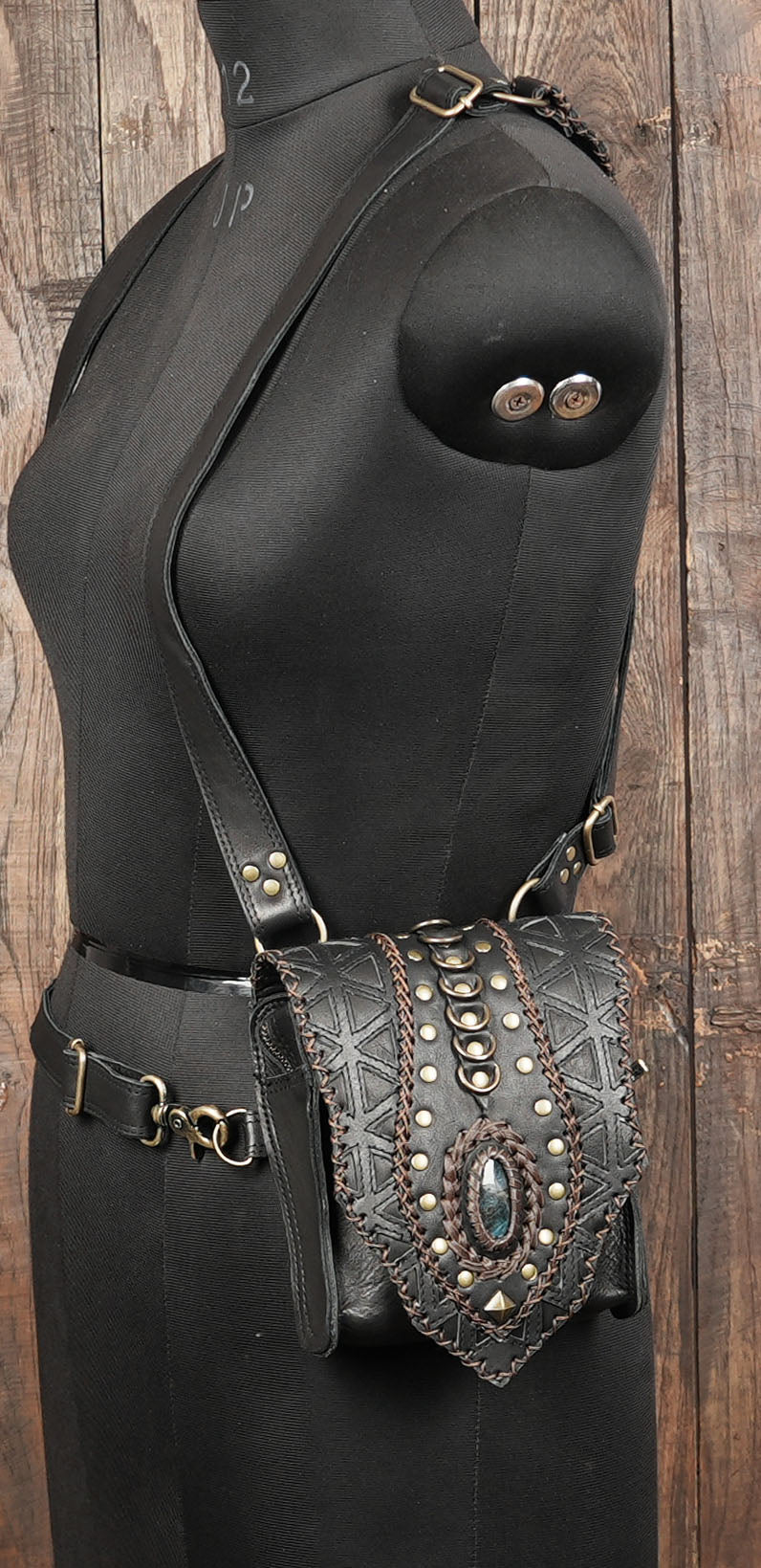 “Black leather utility holster with gemstone embellishments and strong buckles”