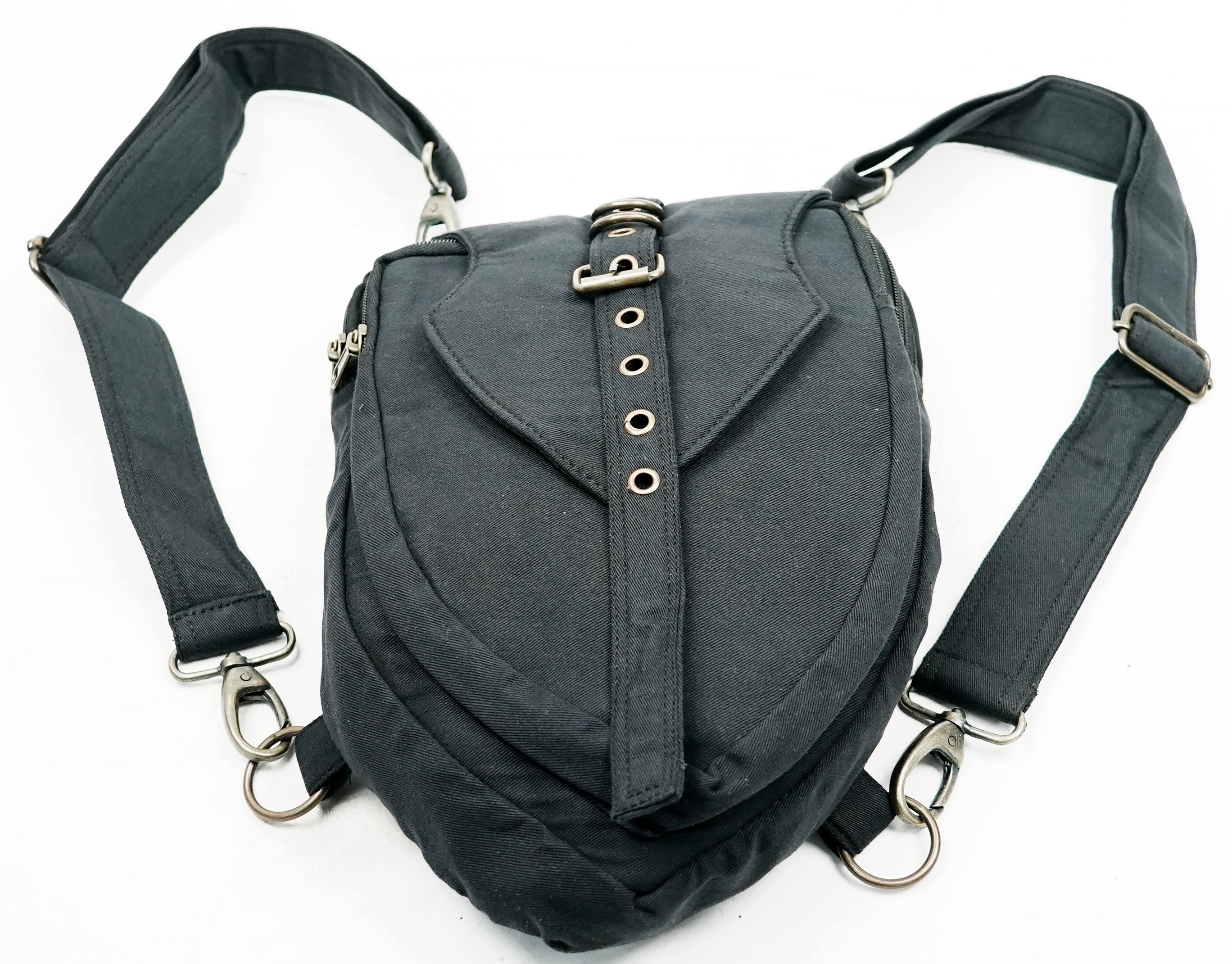 Rugged canvas utility backpack showcasing a decorative buckle and eyelets