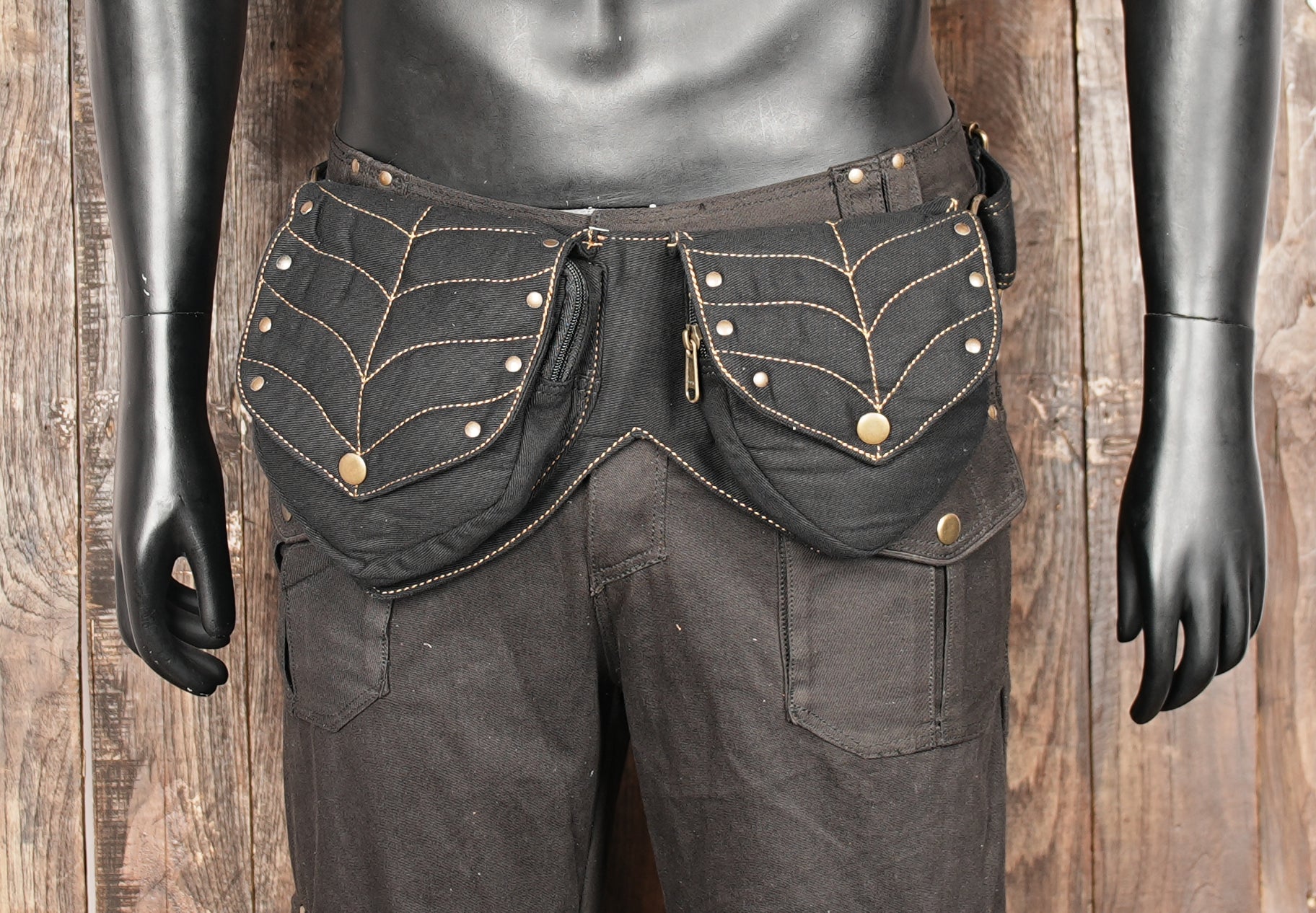 Black canvas hip pouch featuring brass snaps and durable design