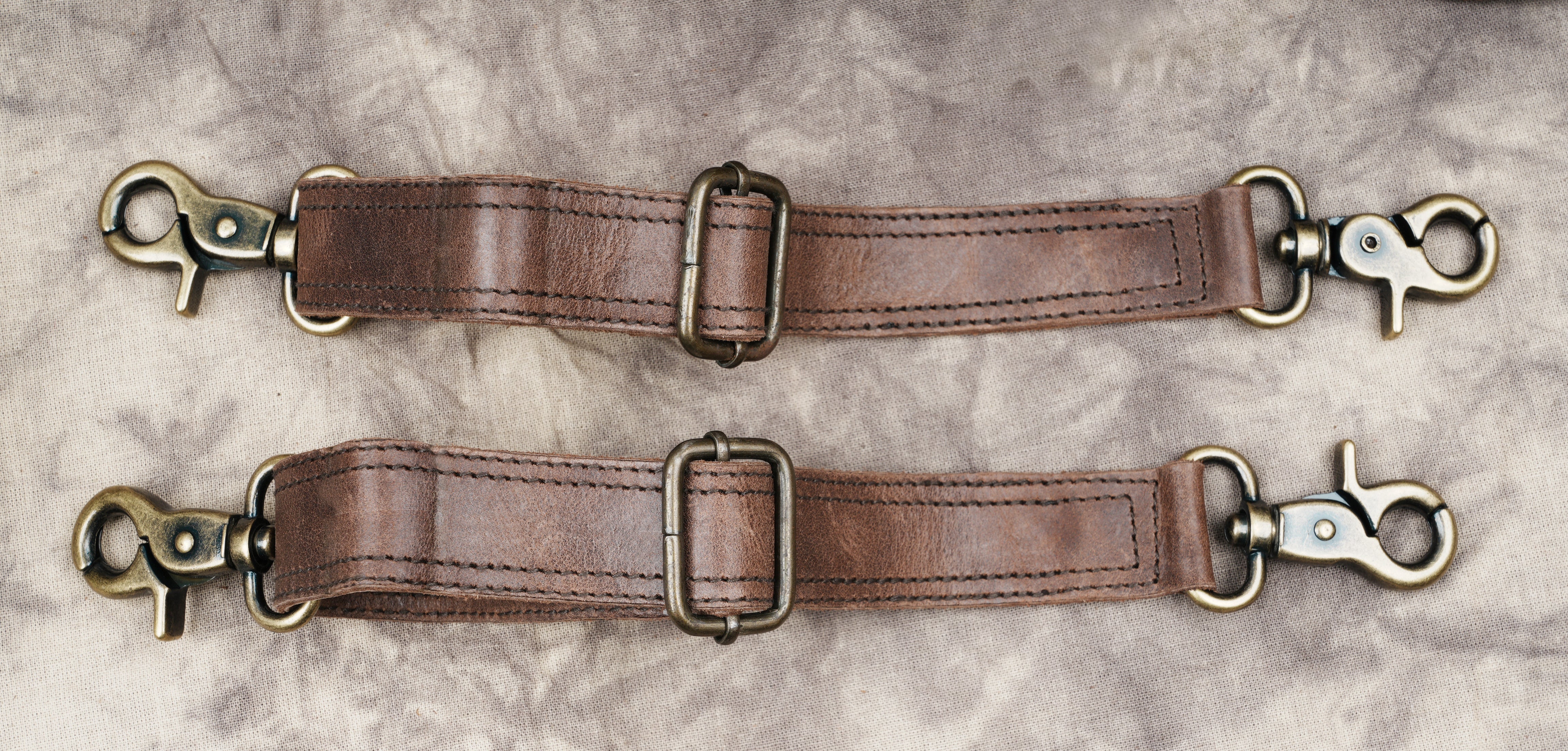 Brown leather dual pouch holster with gemstone centerpiece